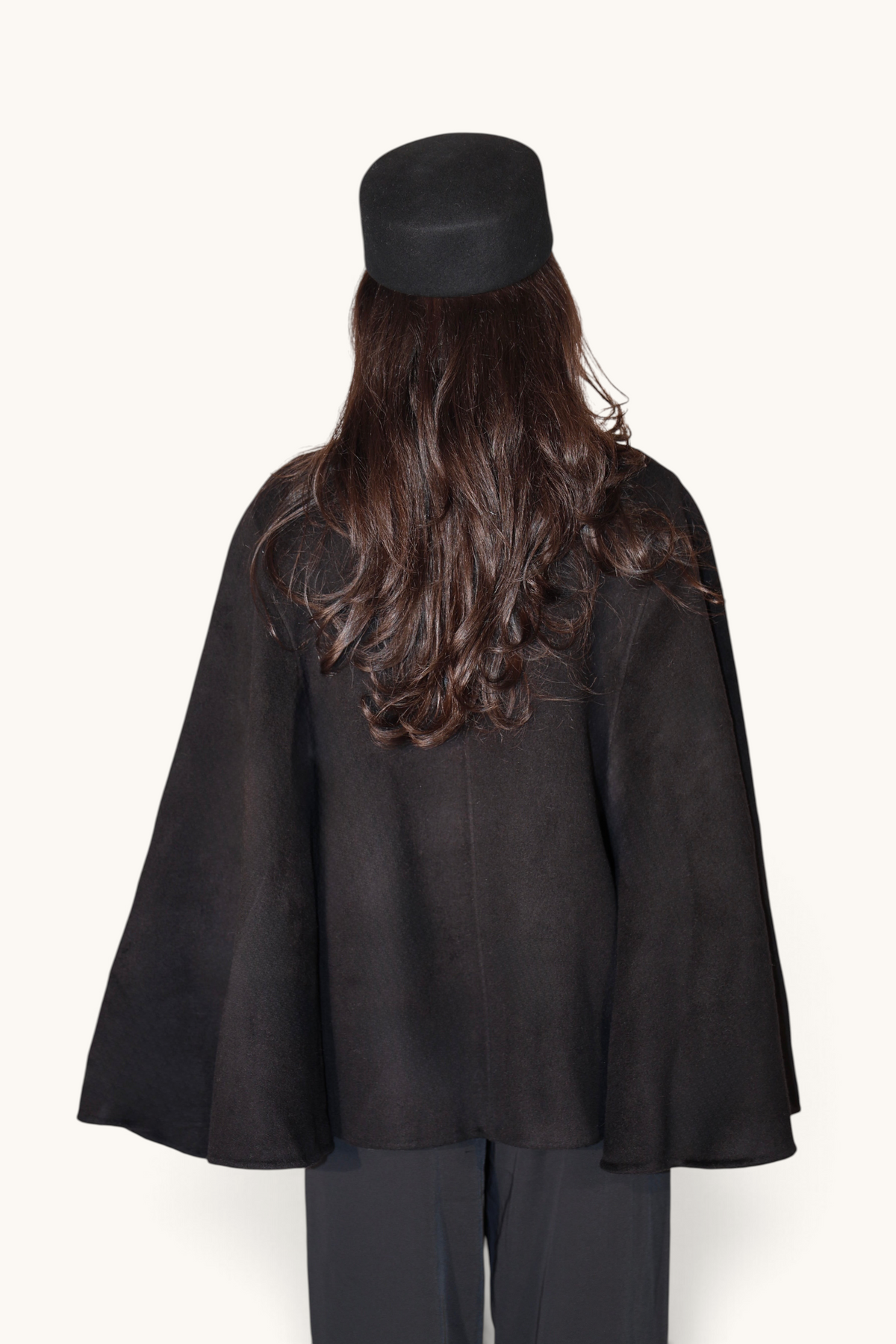 Schwarze Wollcape Jacke von LOSYANA, weiche Textur, längeres Design, perfekt für kalte Tage, stilvoll und warm.