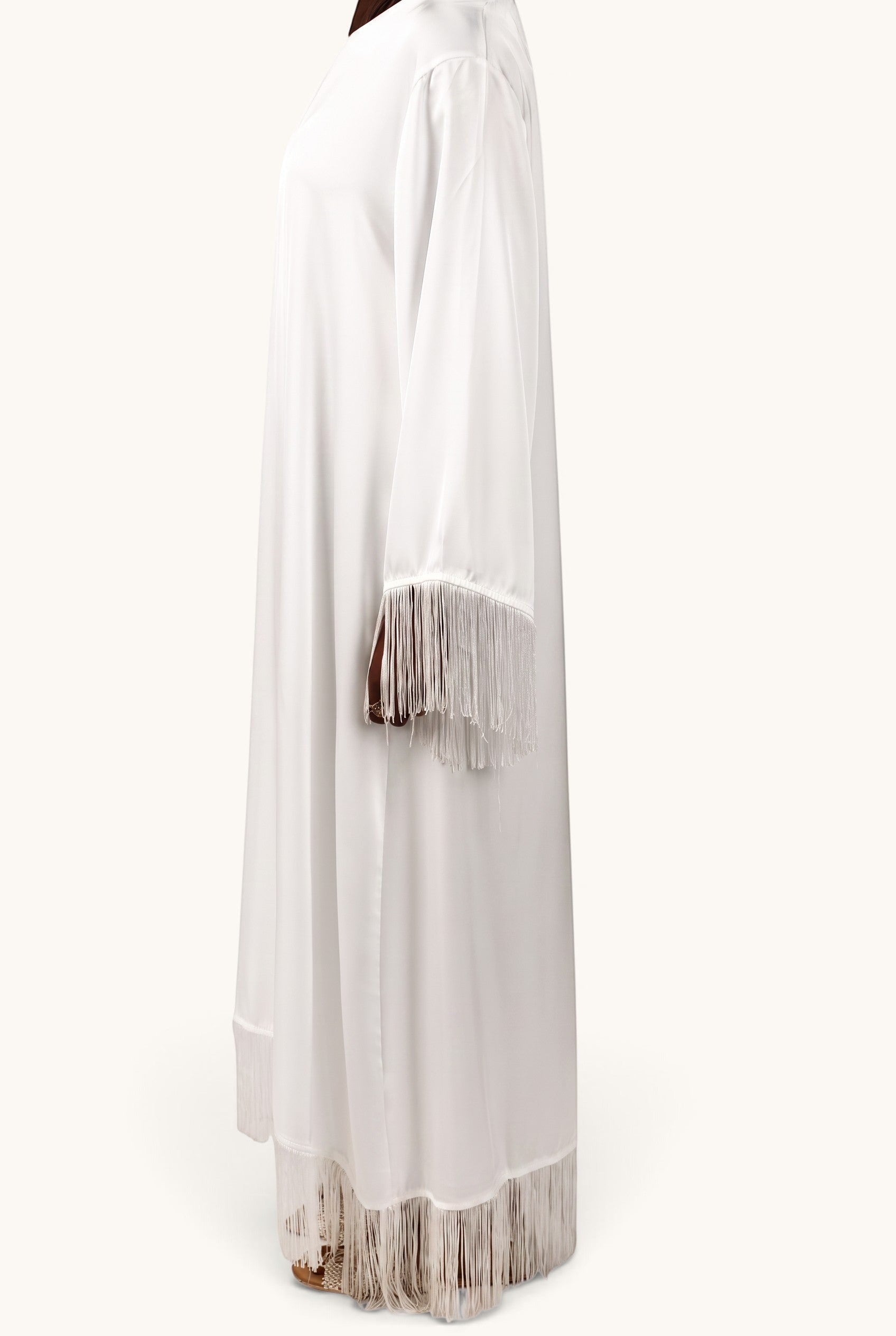 LOSYANA Barcelona white satin dress featuring elegant fringe detailing on the sleeves and hemline, side view.