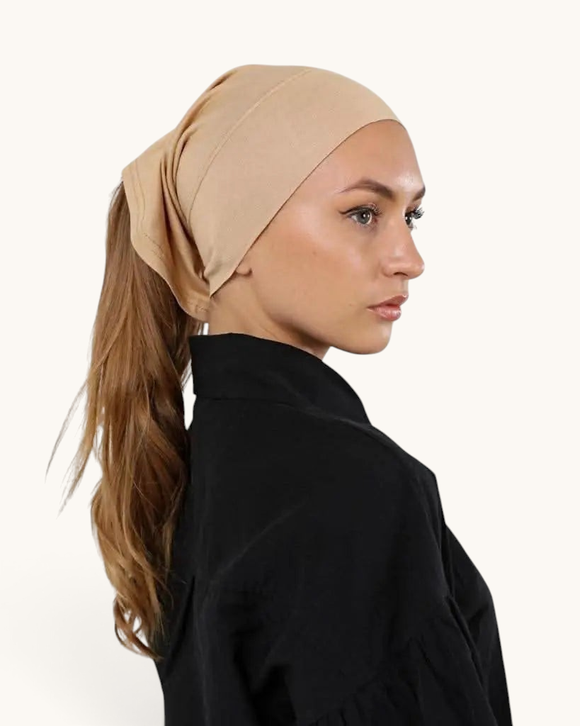 LOSYANA beige open-back underscarf worn by a woman with a ponytail, providing comfort under a hijab.