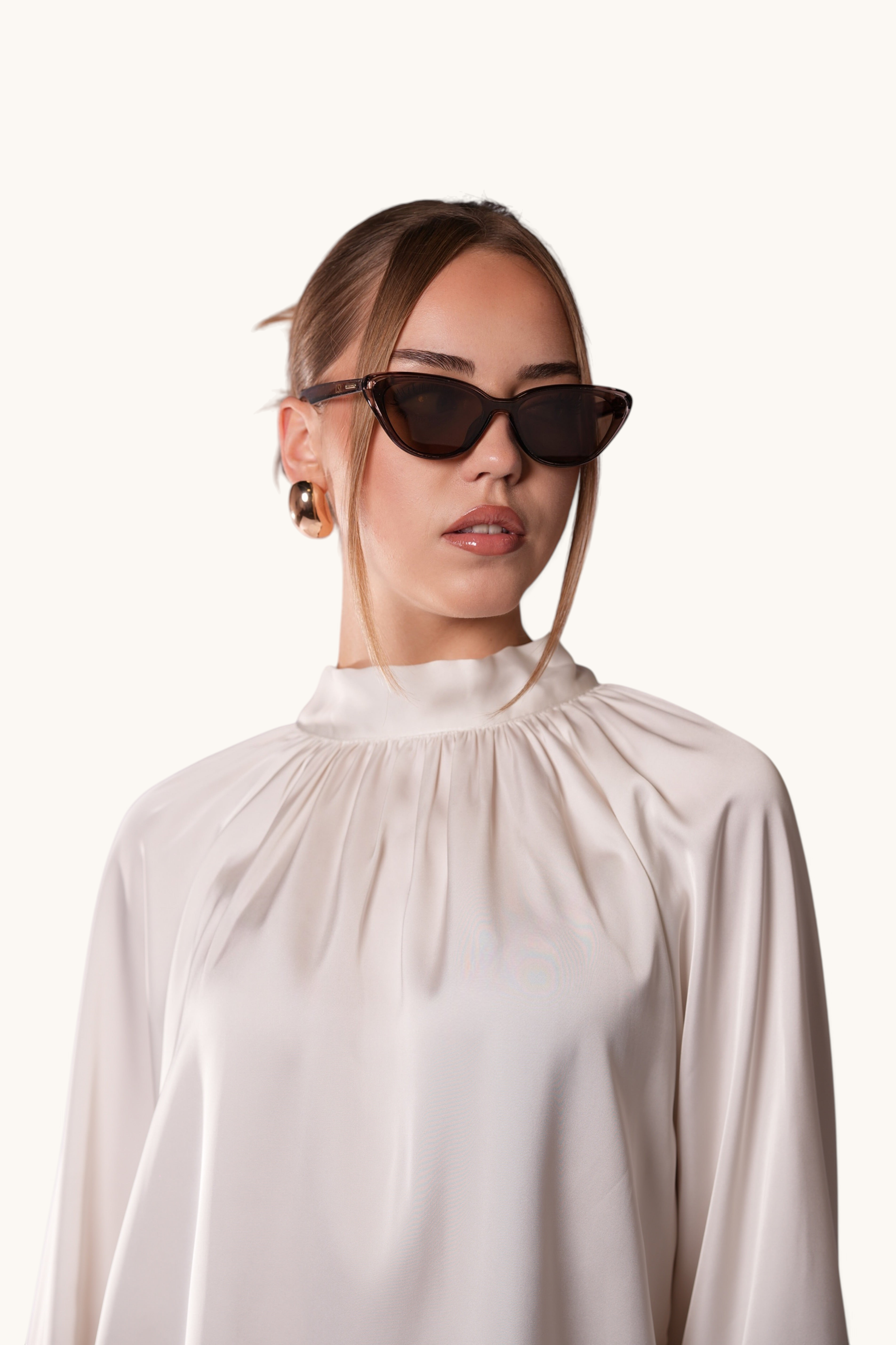 LOSYANA brown cat-eye sunglasses worn by a woman in a white satin blouse, providing UVA and UVB protection.