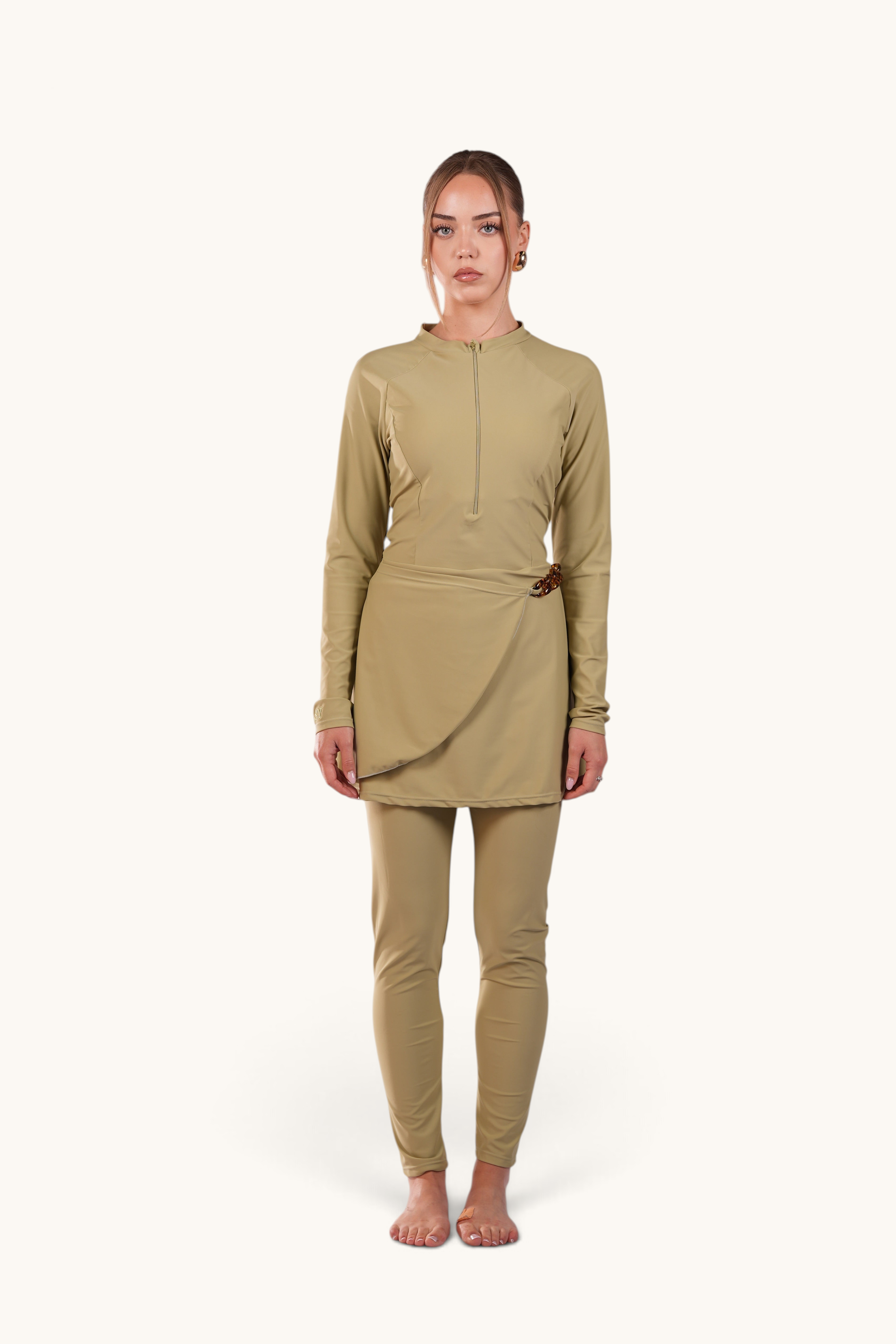 LOSYANA Costa del Sol pistachio green burkini with long sleeves, front zipper, and elegant hip acrylic chain detail.