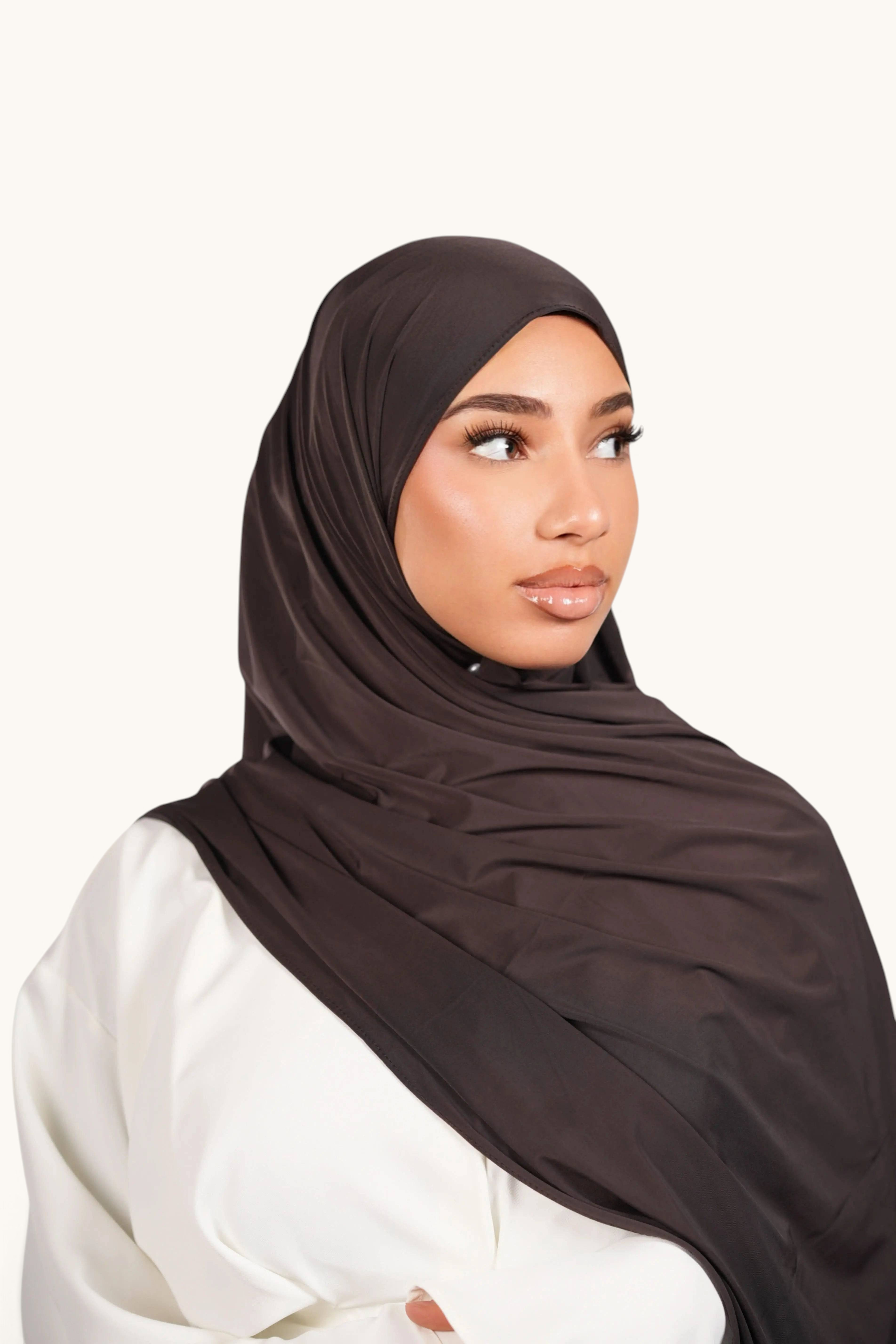 LOSYANA deep brown liquid jersey hijab worn by a model, featuring a lightweight, elegant, and slightly glossy finish.