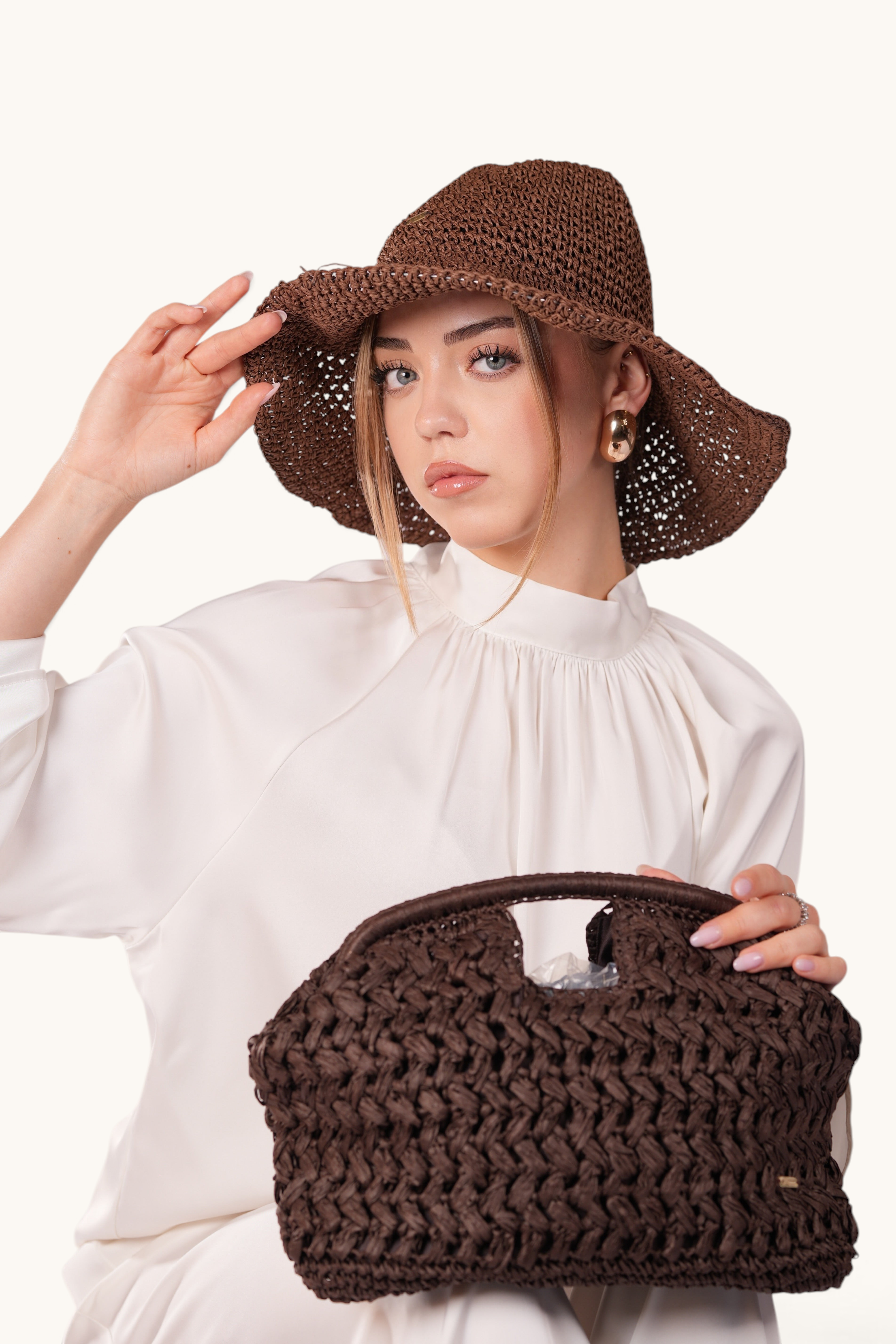 LOSYANA espresso brown handmade straw hat with adjustable brim worn by a woman in a white blouse