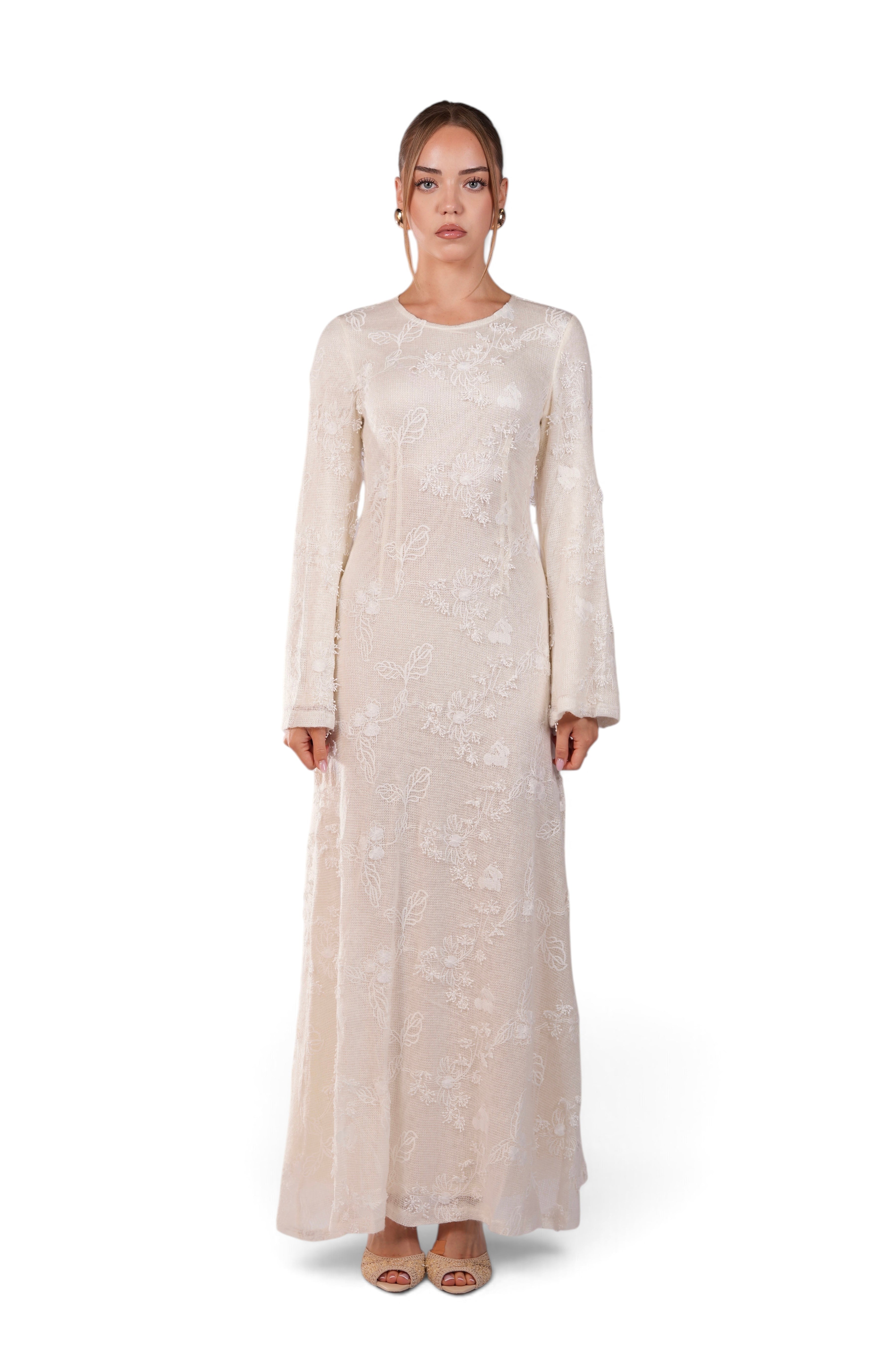 LOSYANA Fuerteventura elegant cream lace maxi dress with round neck and trumpet sleeves worn by a model