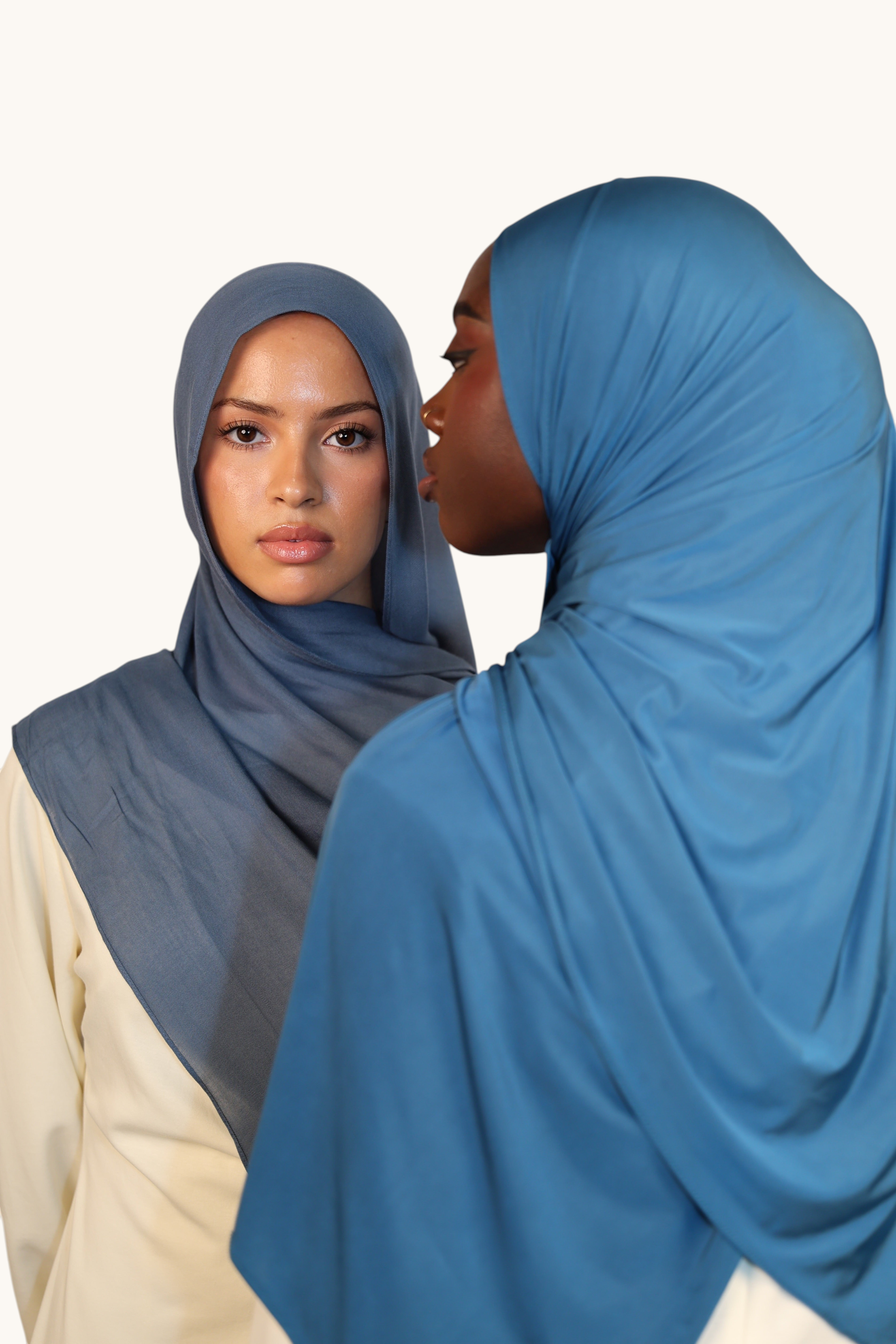 Two models wearing LOSYANA ice blue liquid jersey hijabs with a soft, elegant sheen and breathable fabric.