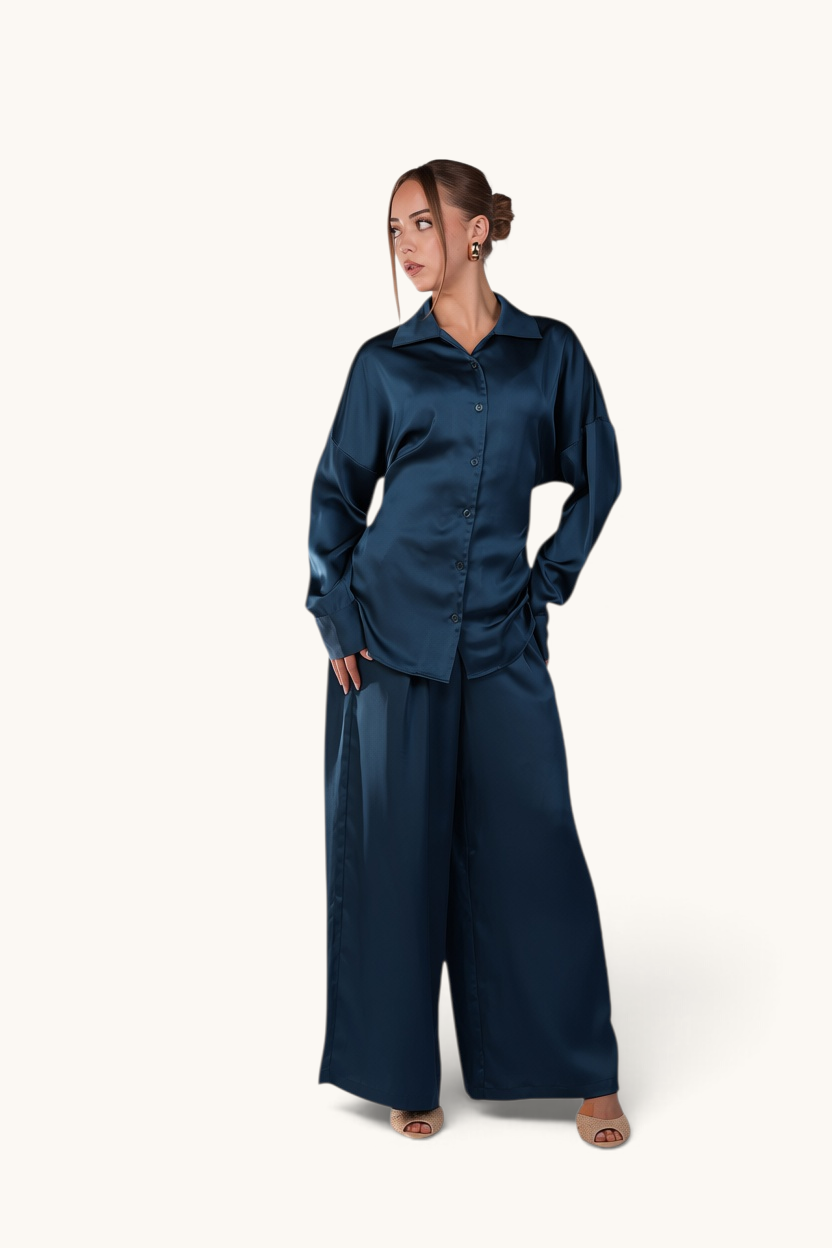 LOSYANA La Laguna teal satin two-piece set featuring a button-down blouse and wide-leg trousers on a model.
