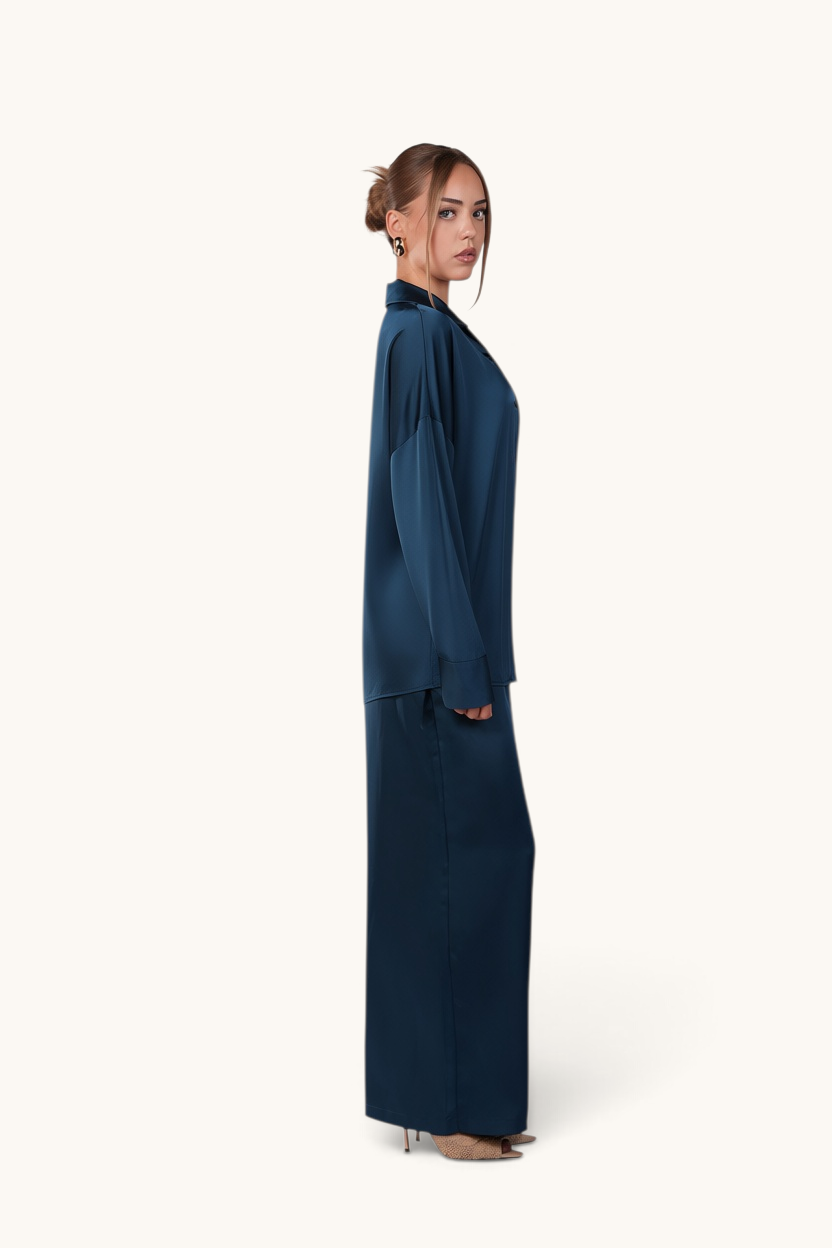 LOSYANA La Laguna teal satin two-piece set with a flowing blouse and wide-leg trousers worn by a model
