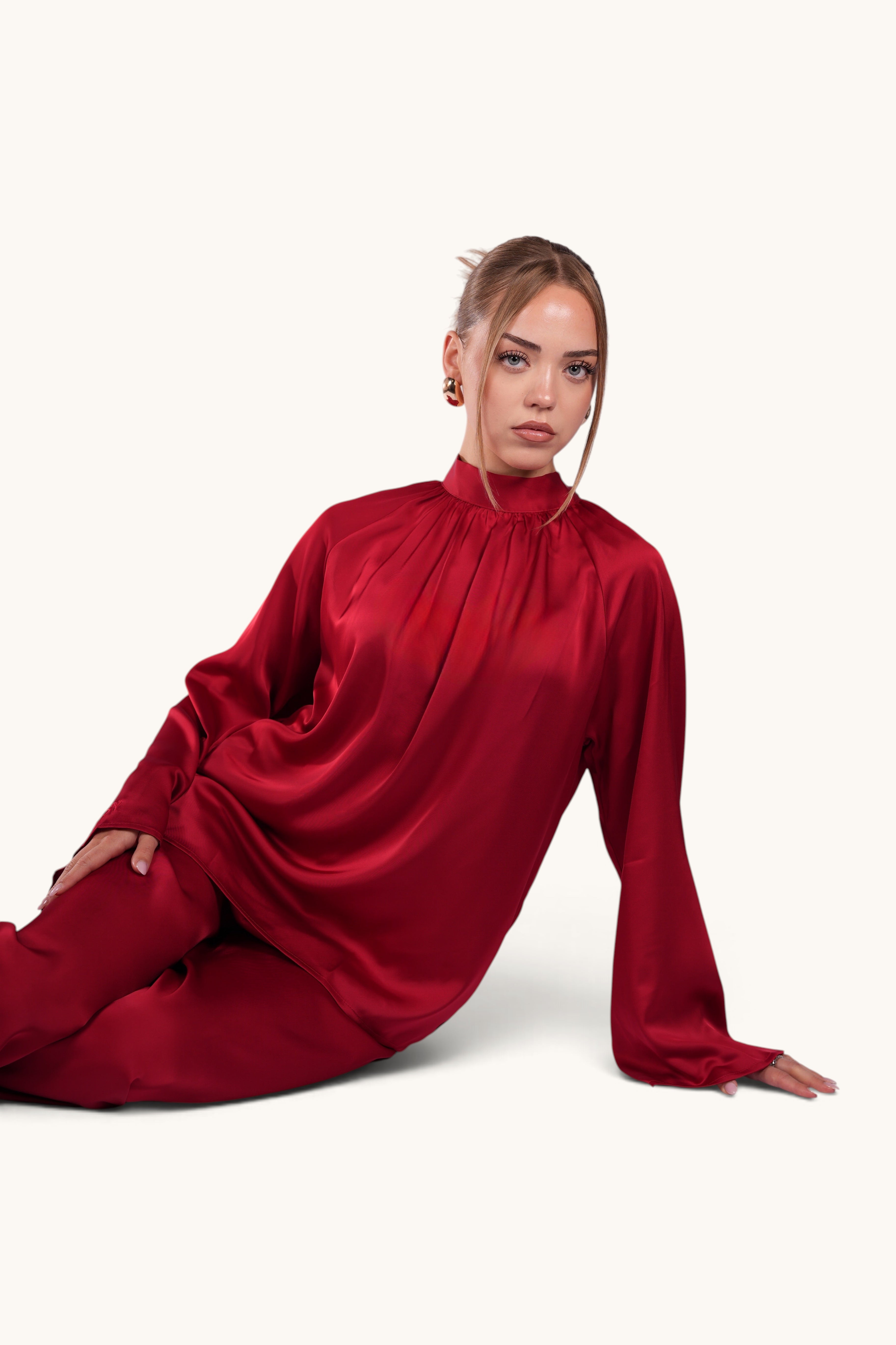 LOSYANA La Palma red satin two-piece set with high collar top and wide-leg trousers worn by a model