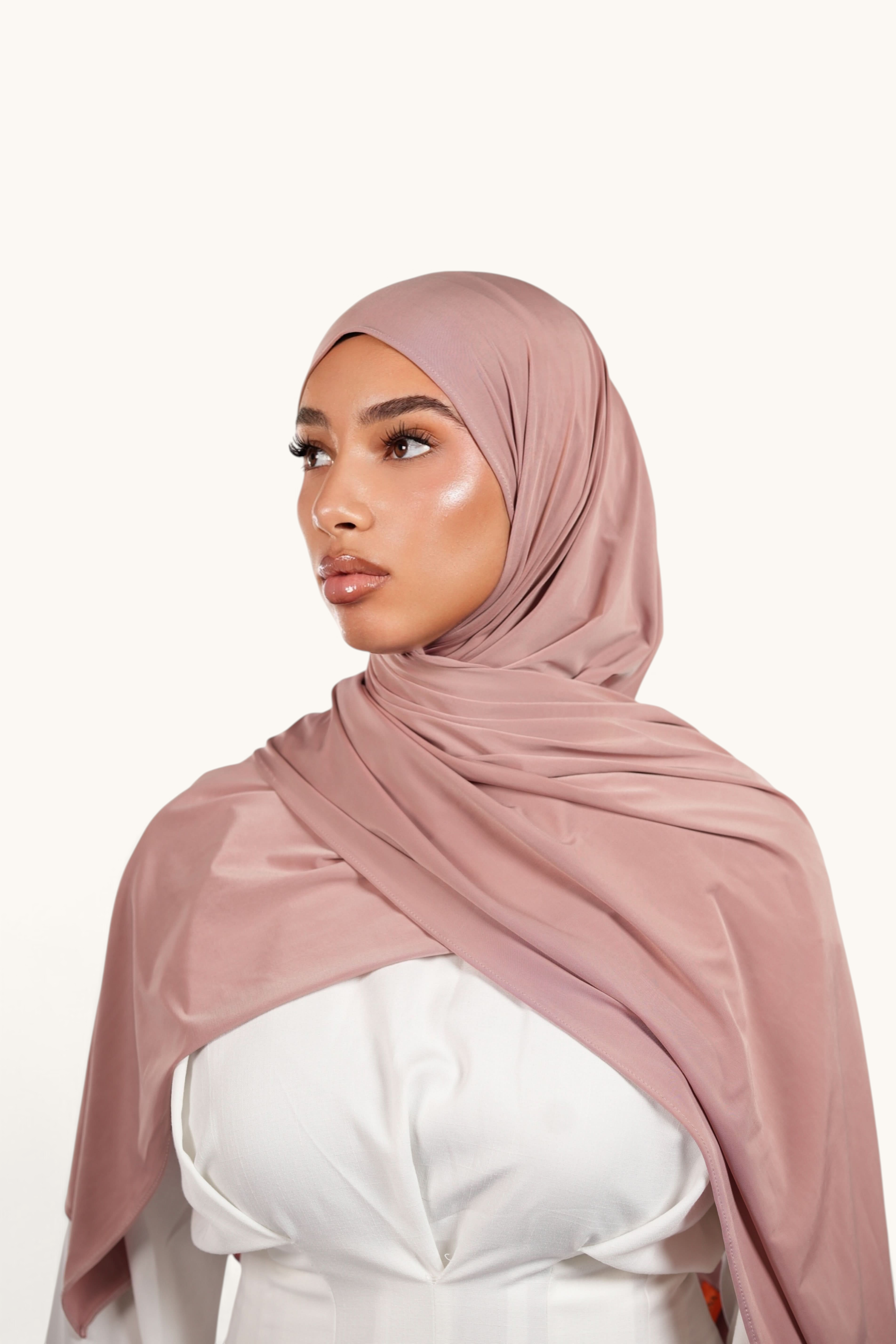 LOSYANA Liquid Jersey hijab in almond, a lightweight, subtly shimmering fabric draped elegantly on a model.
