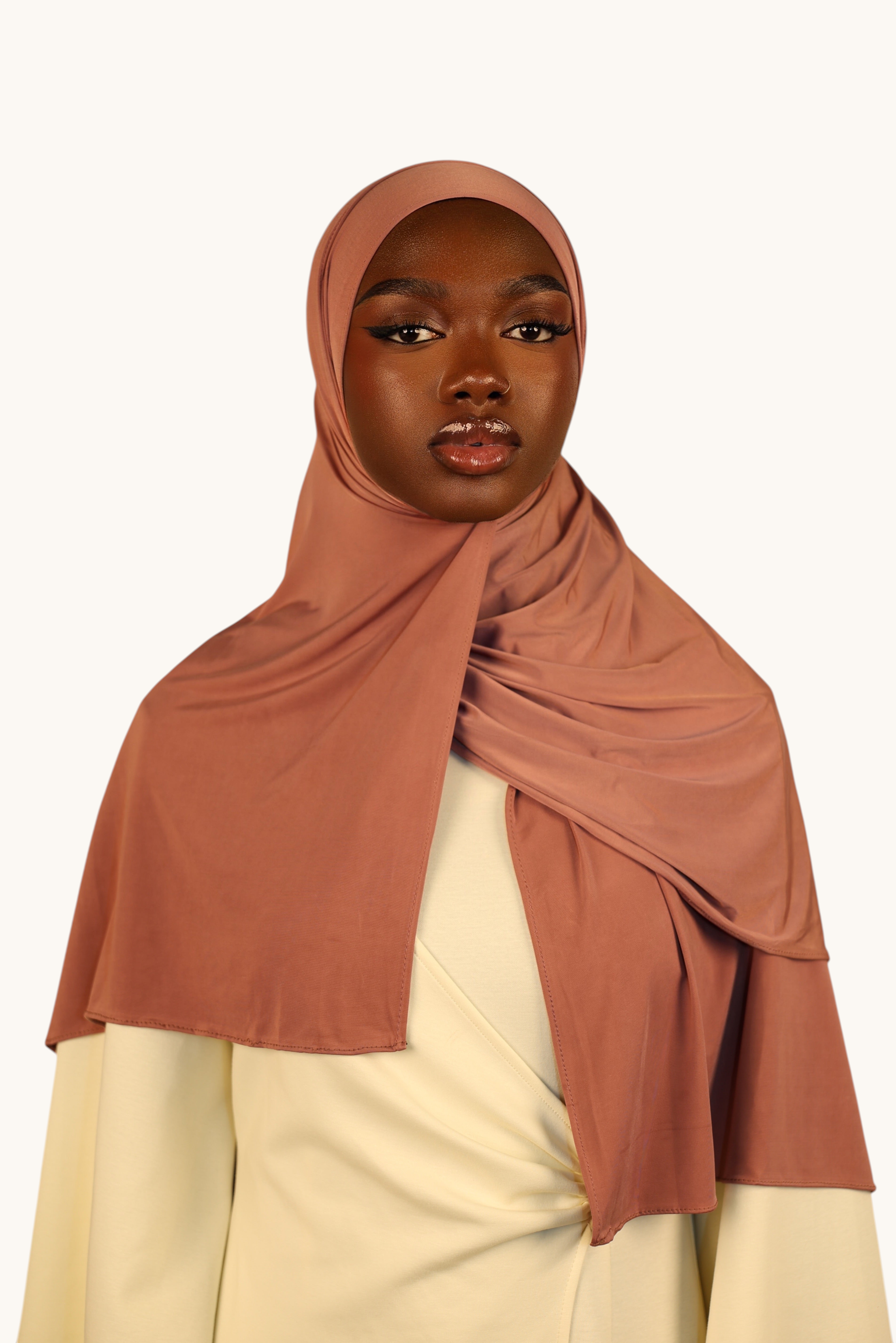 LOSYANA Liquid Jersey hijab in rosewood draped elegantly on a model with a light cream top