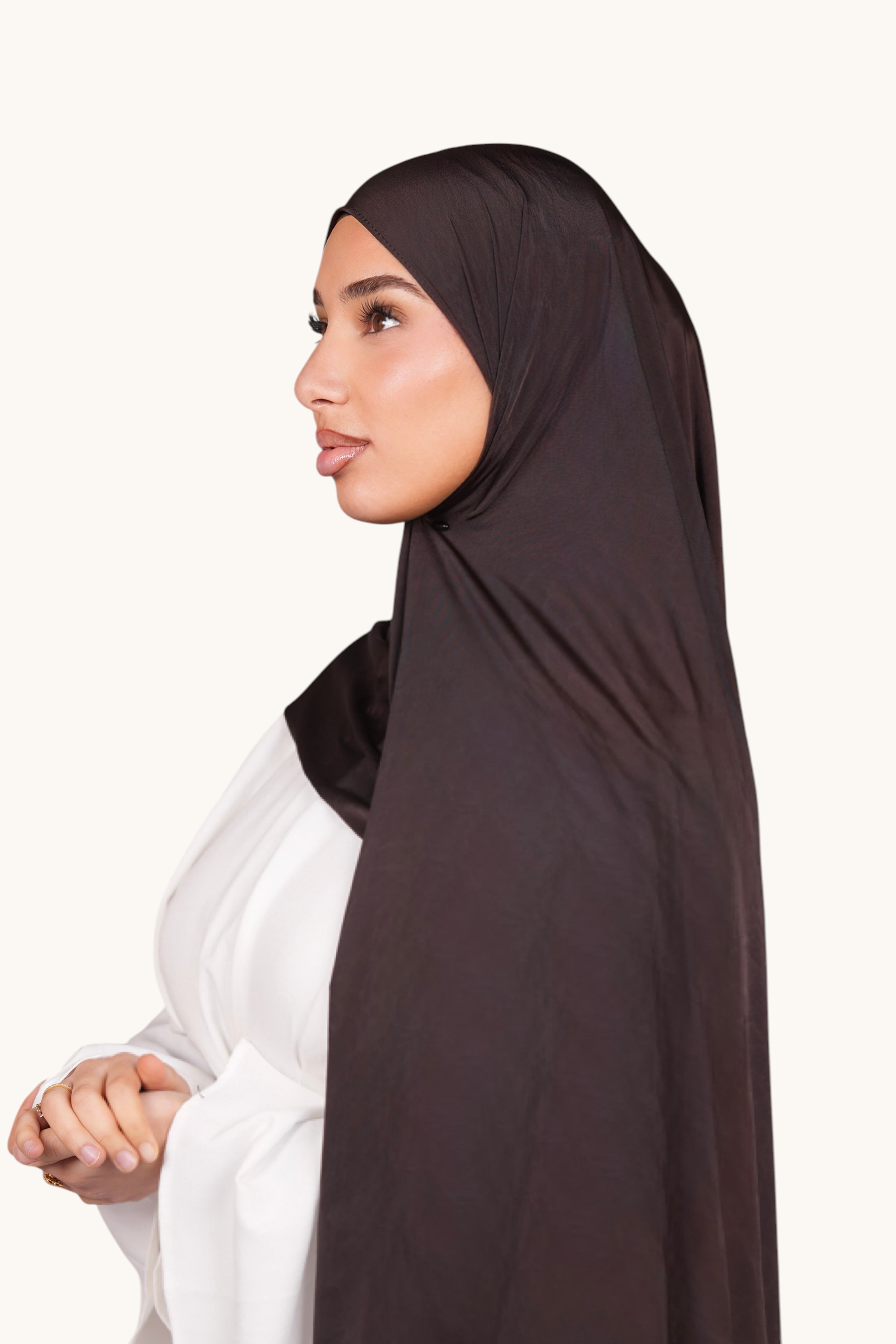 LOSYANA Liquid Jersey hijab in smokey chocolate worn by a model, featuring a lightweight, elegant satin-like finish.