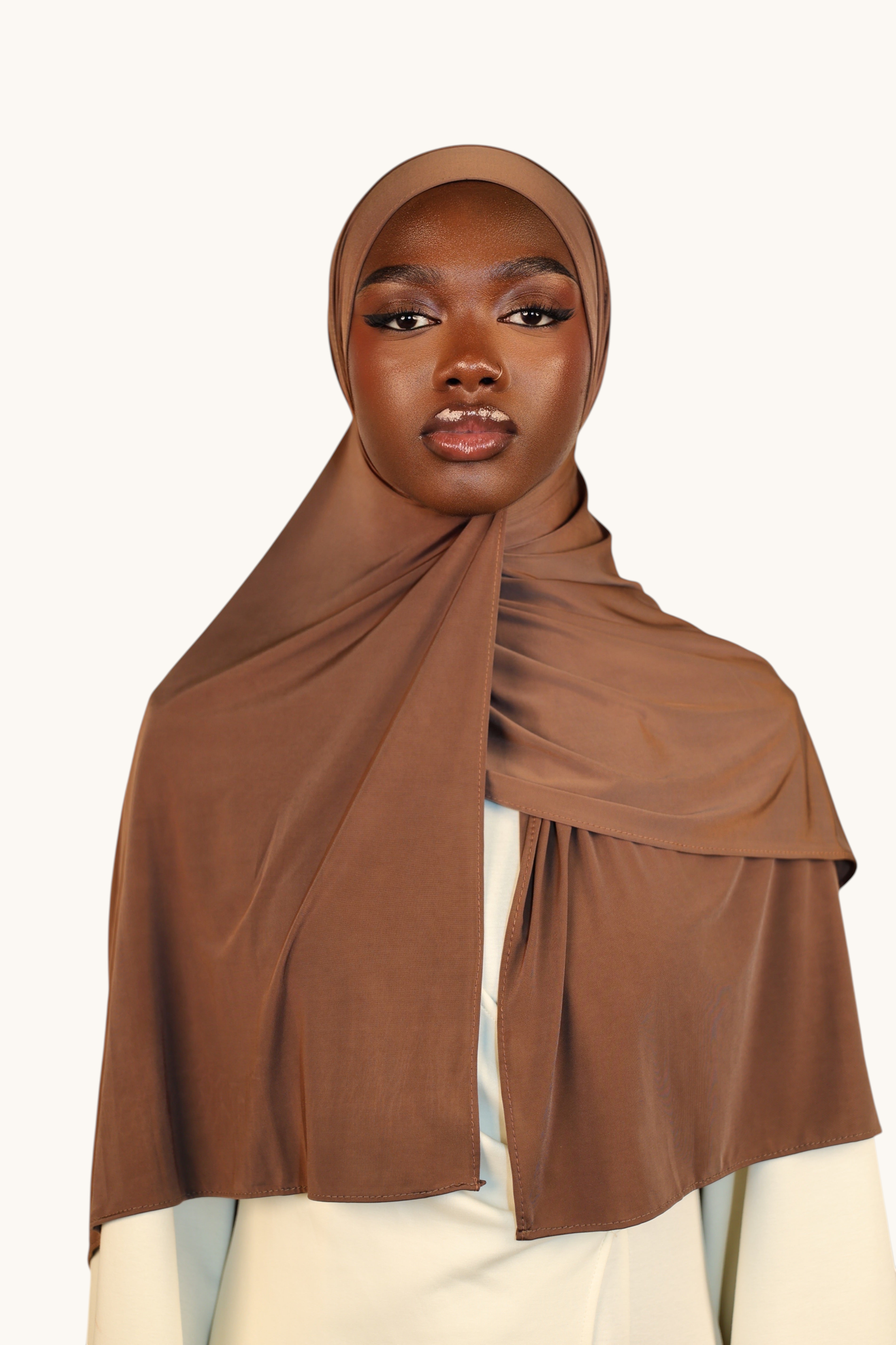 LOSYANA Liquid Jersey hijab in toffee brown, featuring a lightweight, slightly glossy fabric draped elegantly.