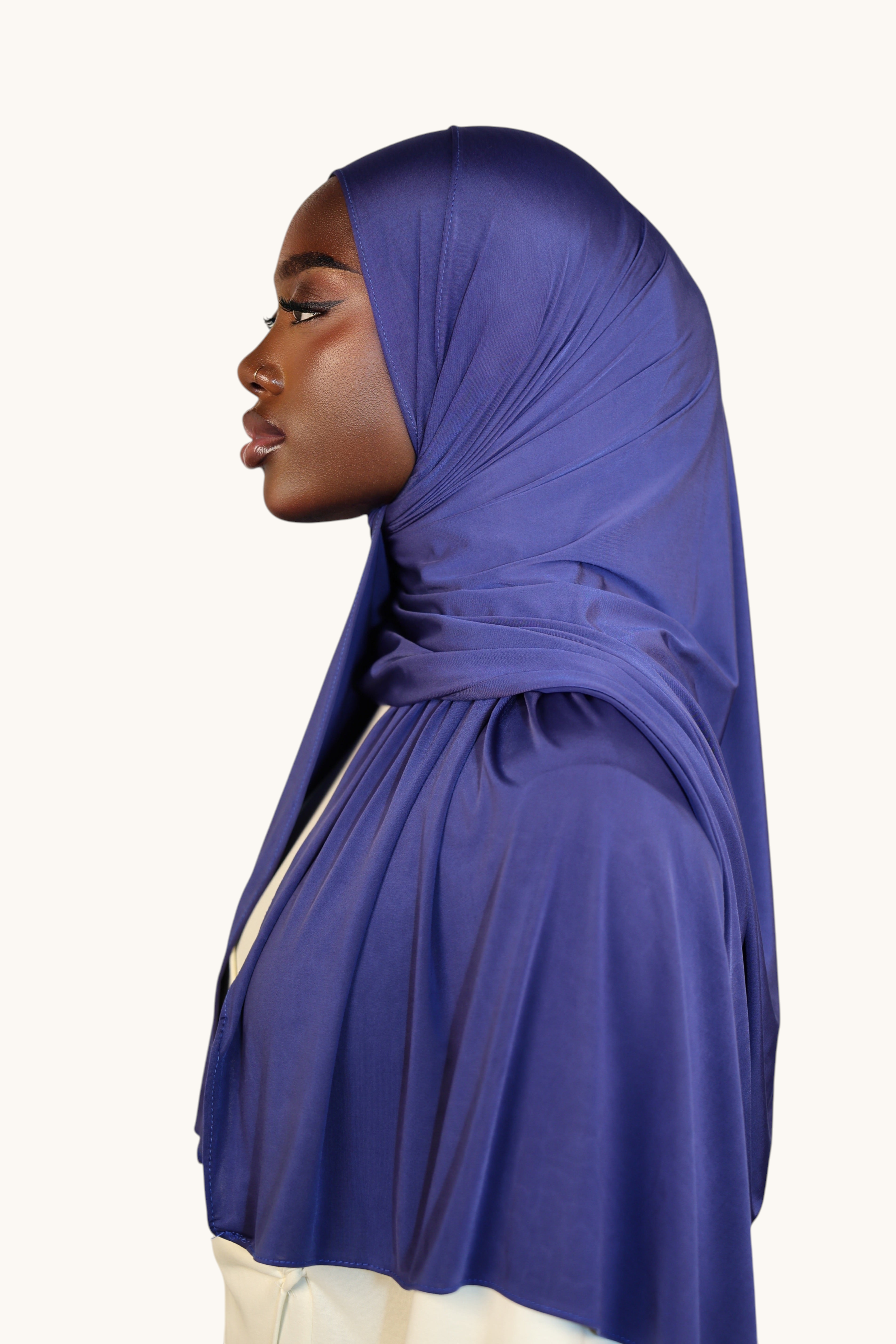Model wearing a LOSYANA Liquid Jersey hijab in sapphire blue, featuring a lightweight, elegant satin-like sheen.