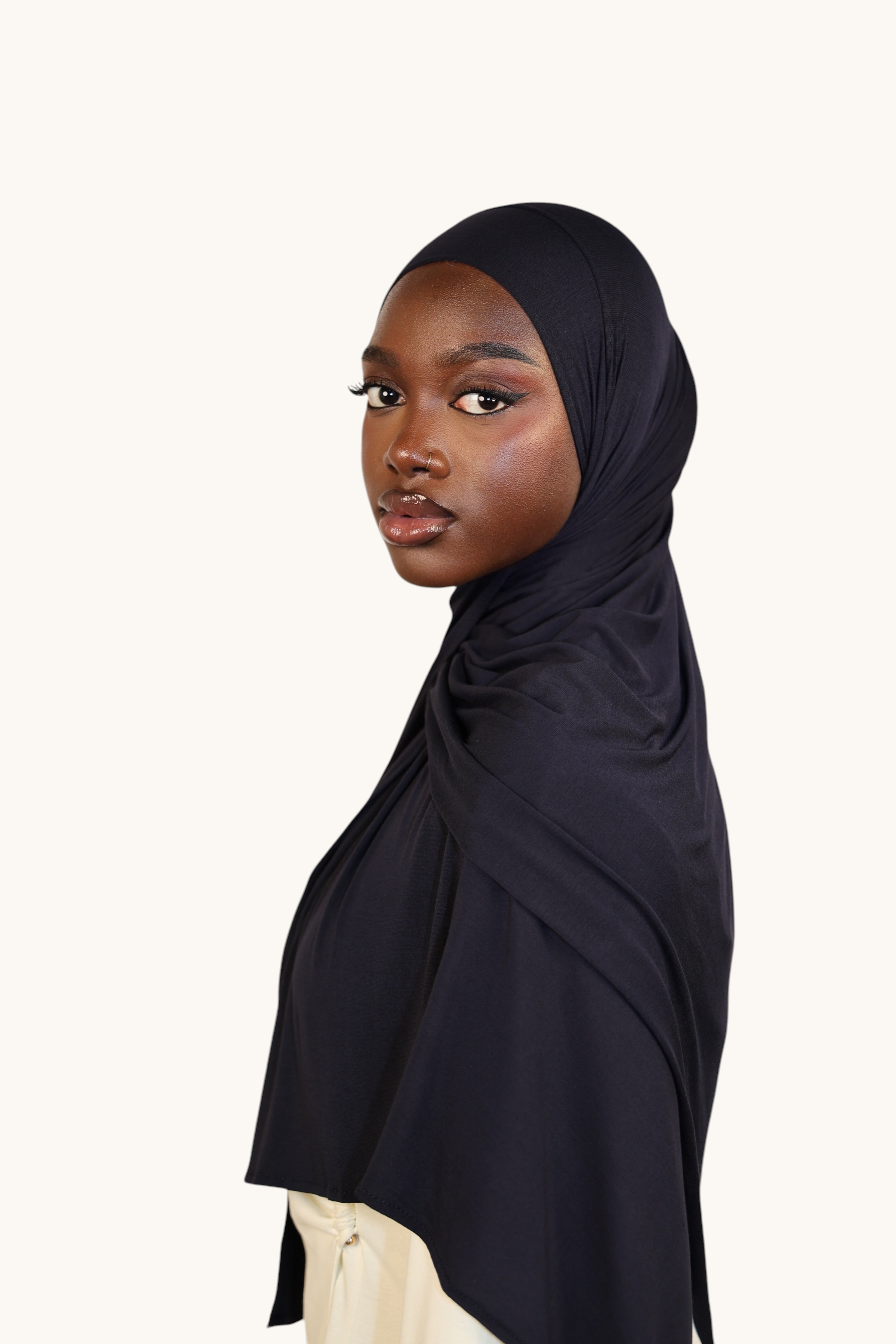 Model wearing a LOSYANA navy Vela Jersey hijab made from soft, breathable fabric against a neutral background.