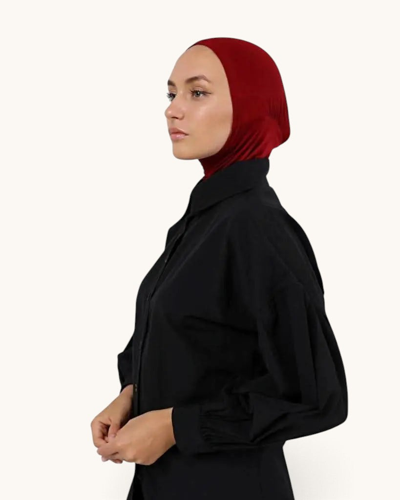 LOSYANA bone underscarf in deep red worn by a model under a black shirt for comfortable hijab styling