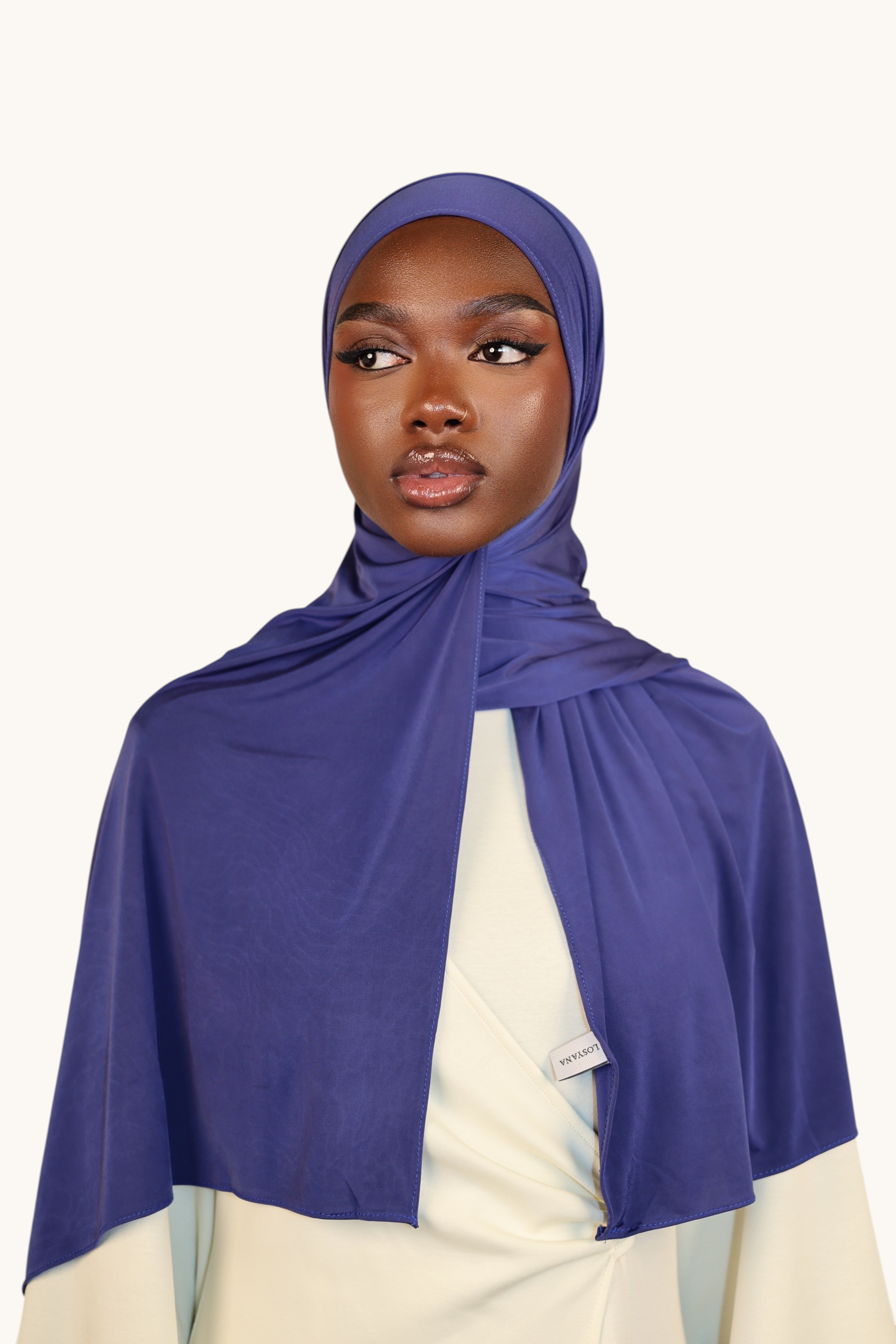 LOSYANA Liquid Jersey hijab in sapphire blue worn by a model, featuring a lightweight, soft, and subtle sheen fabric.