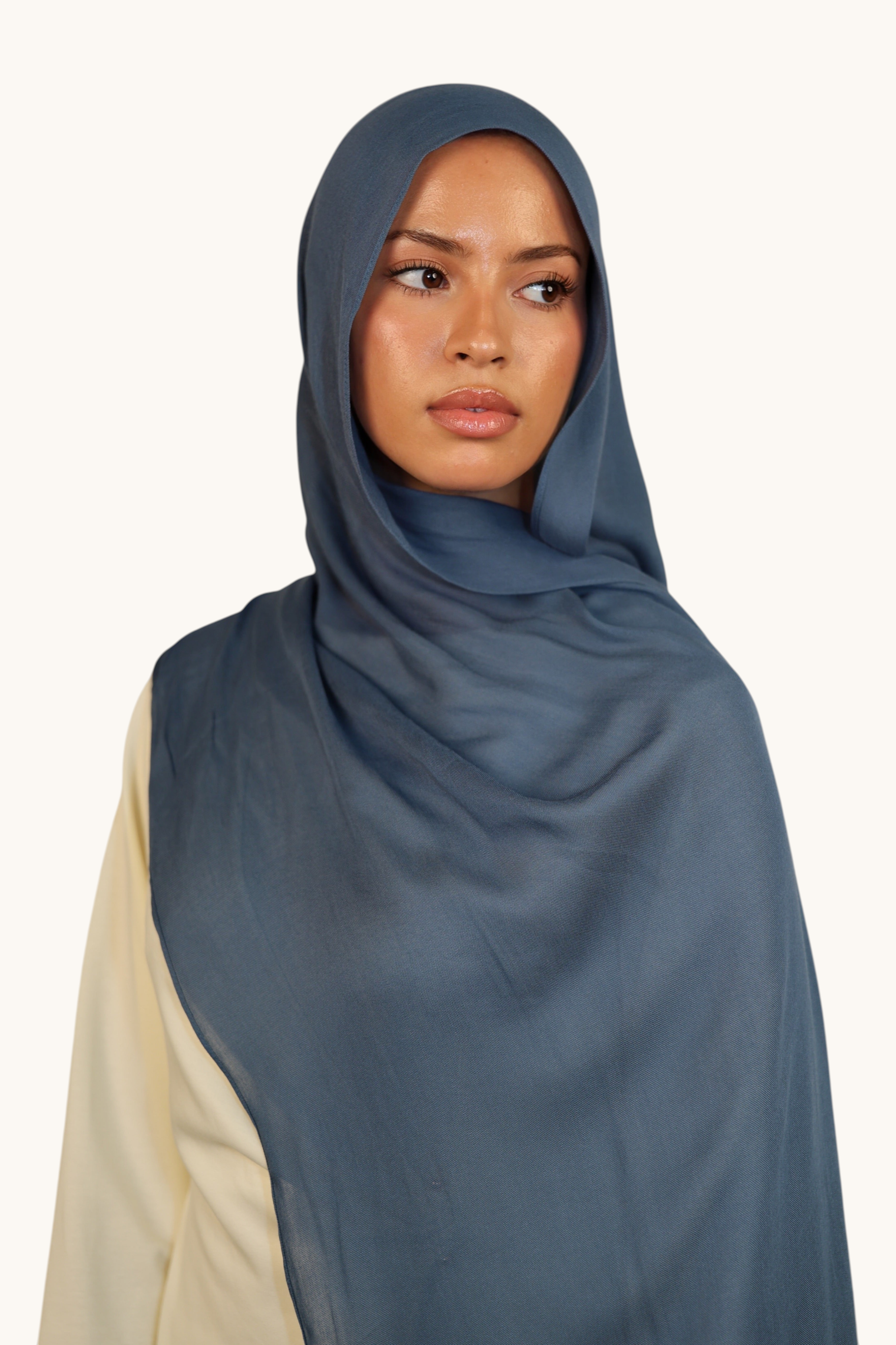 LOSYANA lightweight slate blue modal hijab worn by a model, featuring a soft, elegant, and semi-sheer draped fabric.