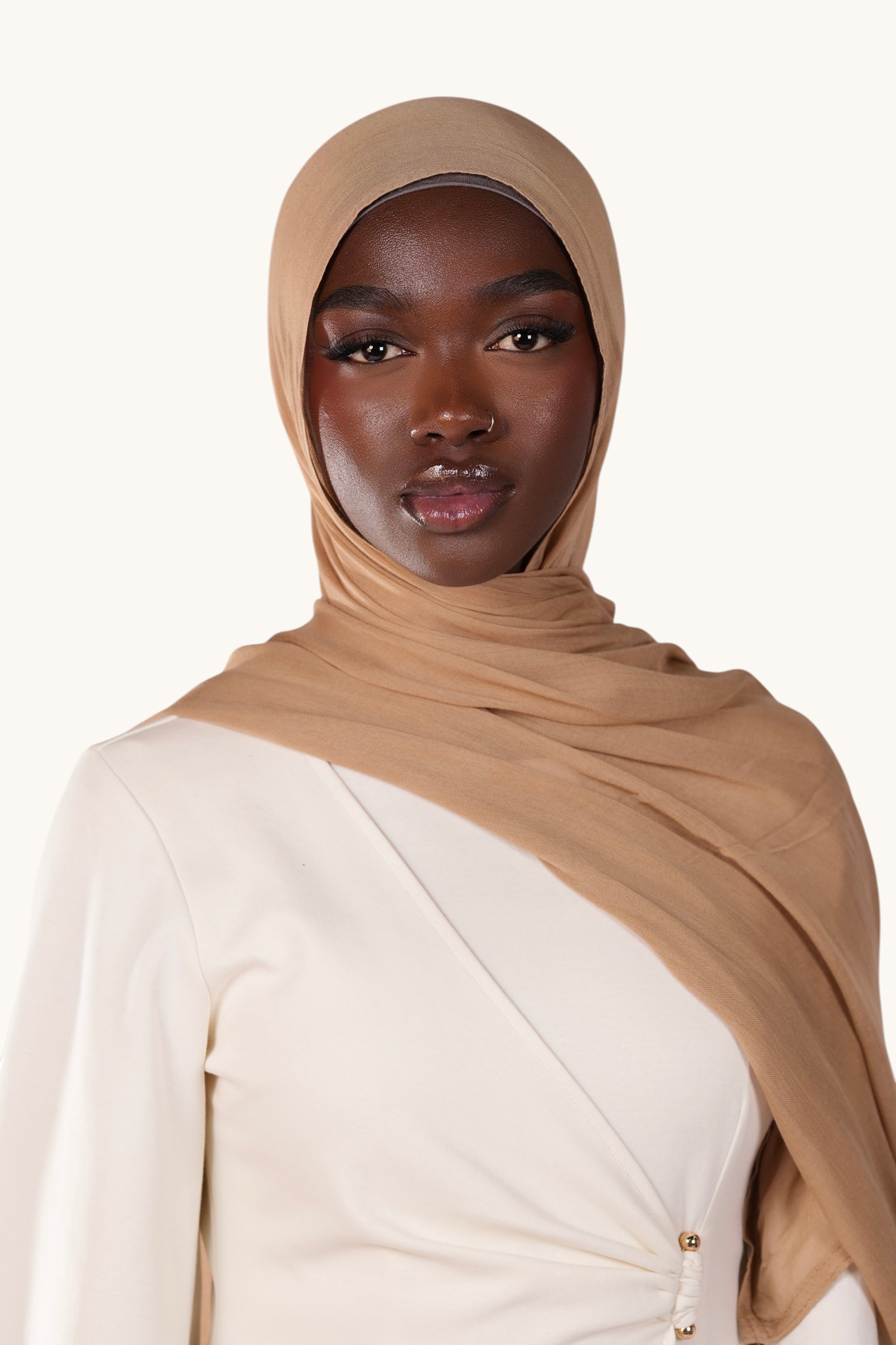 Model wearing a lightweight terracotta modal hijab by LOSYANA, featuring a soft, elegant, and semi-sheer drape.