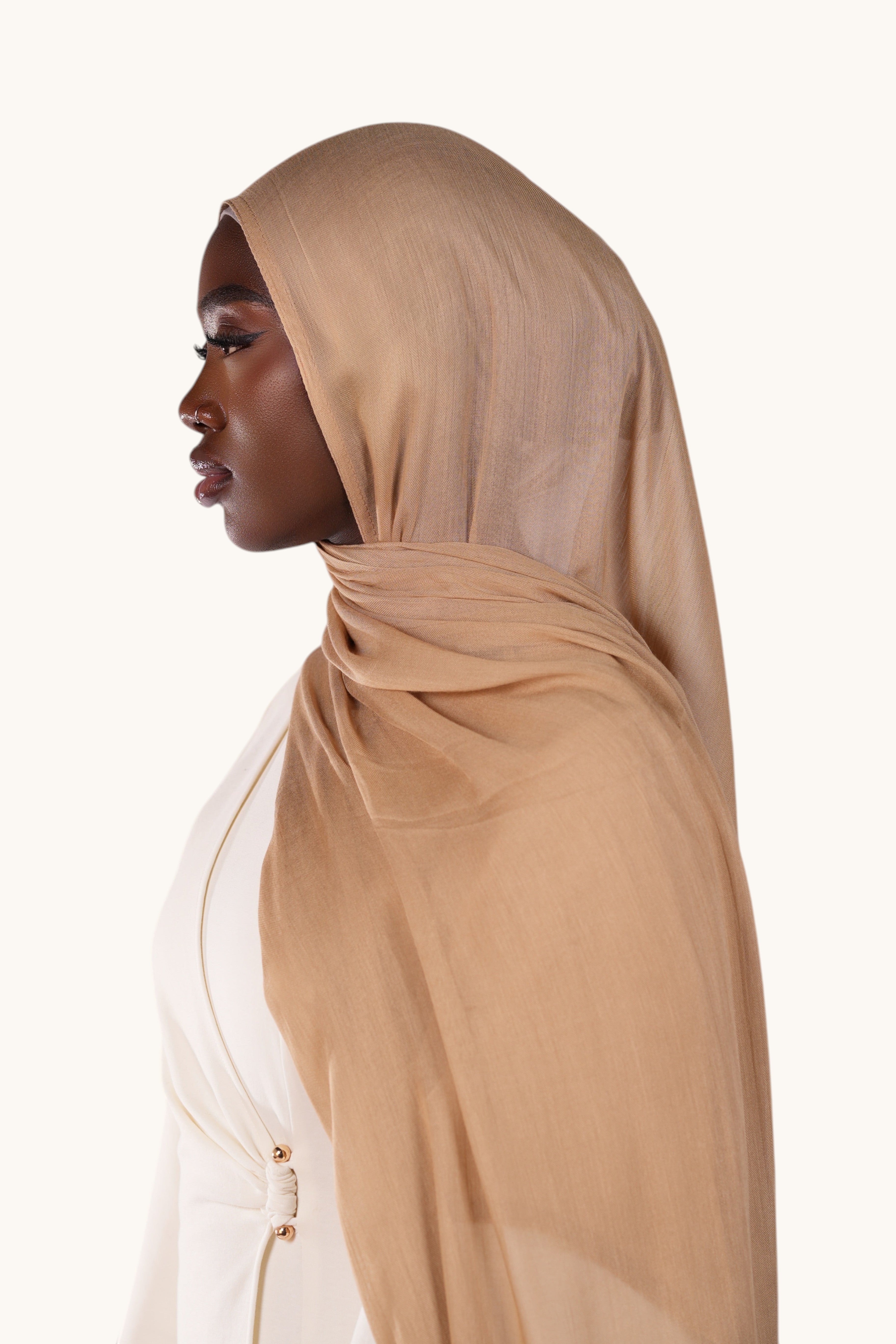 Model wearing a lightweight terracotta modal hijab by LOSYANA, featuring a soft, elegant, and semi-sheer drape.