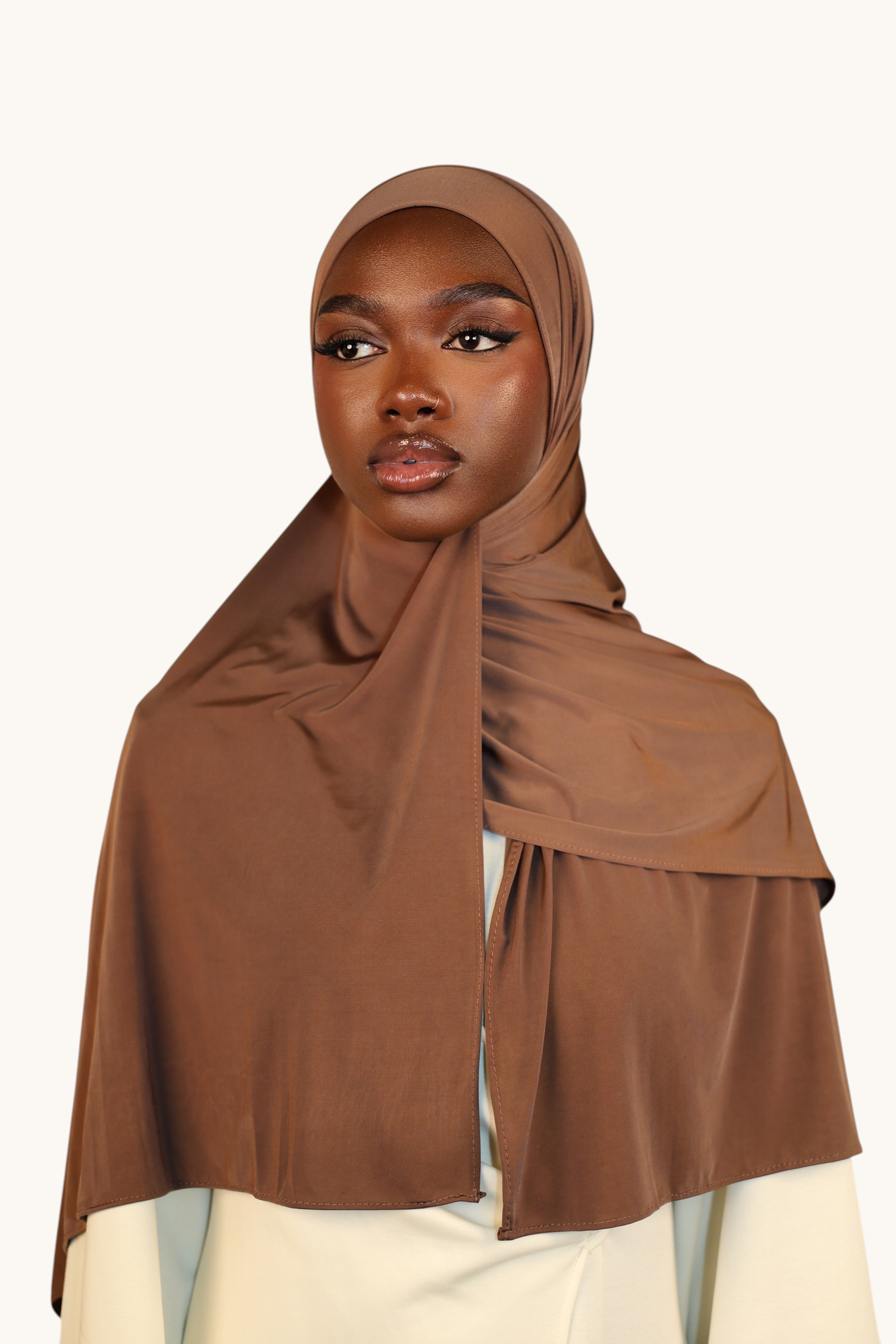 Model wearing a LOSYANA toffee brown liquid jersey hijab with a subtle satin sheen and breathable fabric