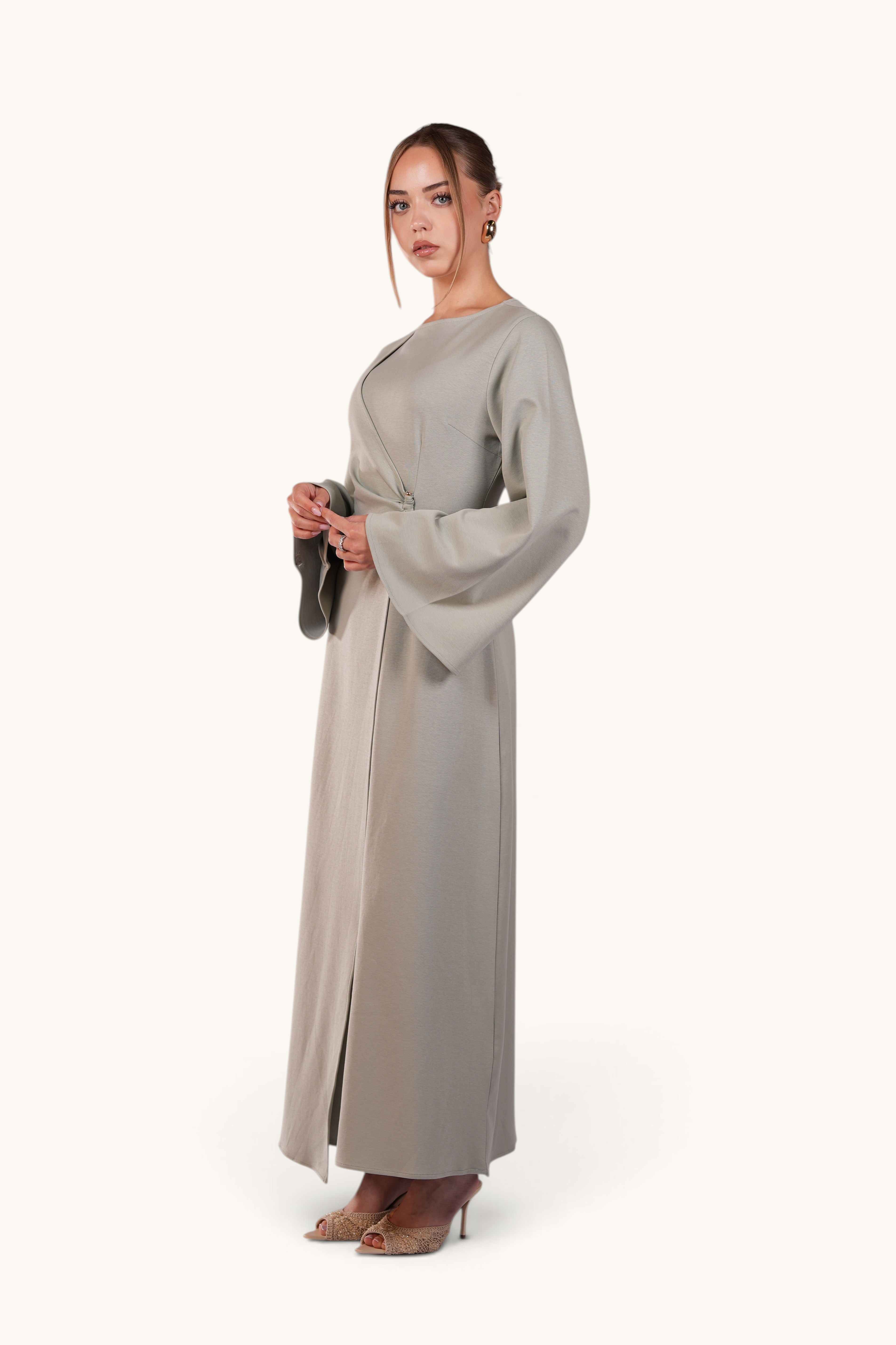LOSYANA Valencia mint green maxi dress with trumpet sleeves and gold waist detail worn by a model