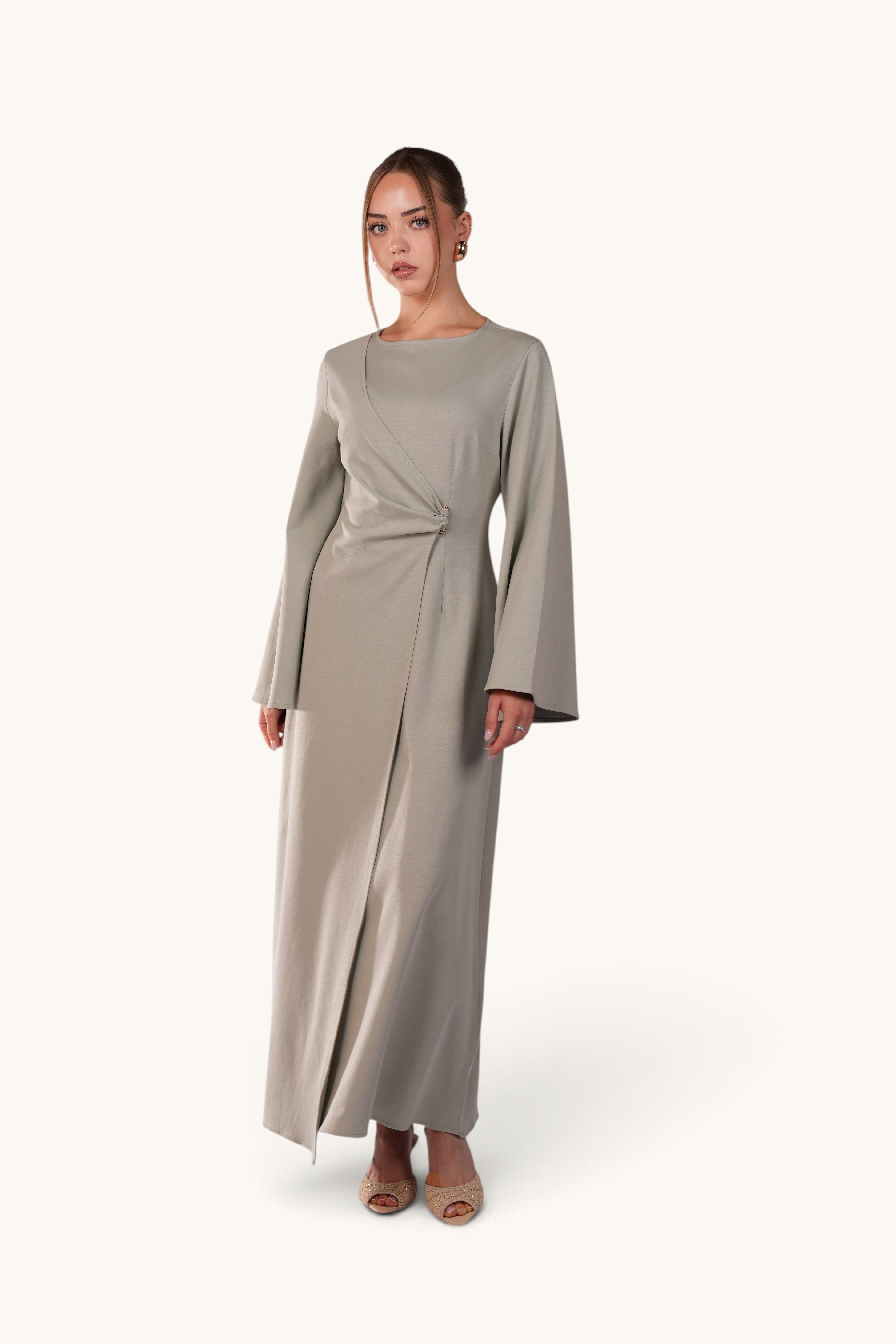 LOSYANA Valencia mint maxi dress with trumpet sleeves, waist gathering, and gold detail worn by a model