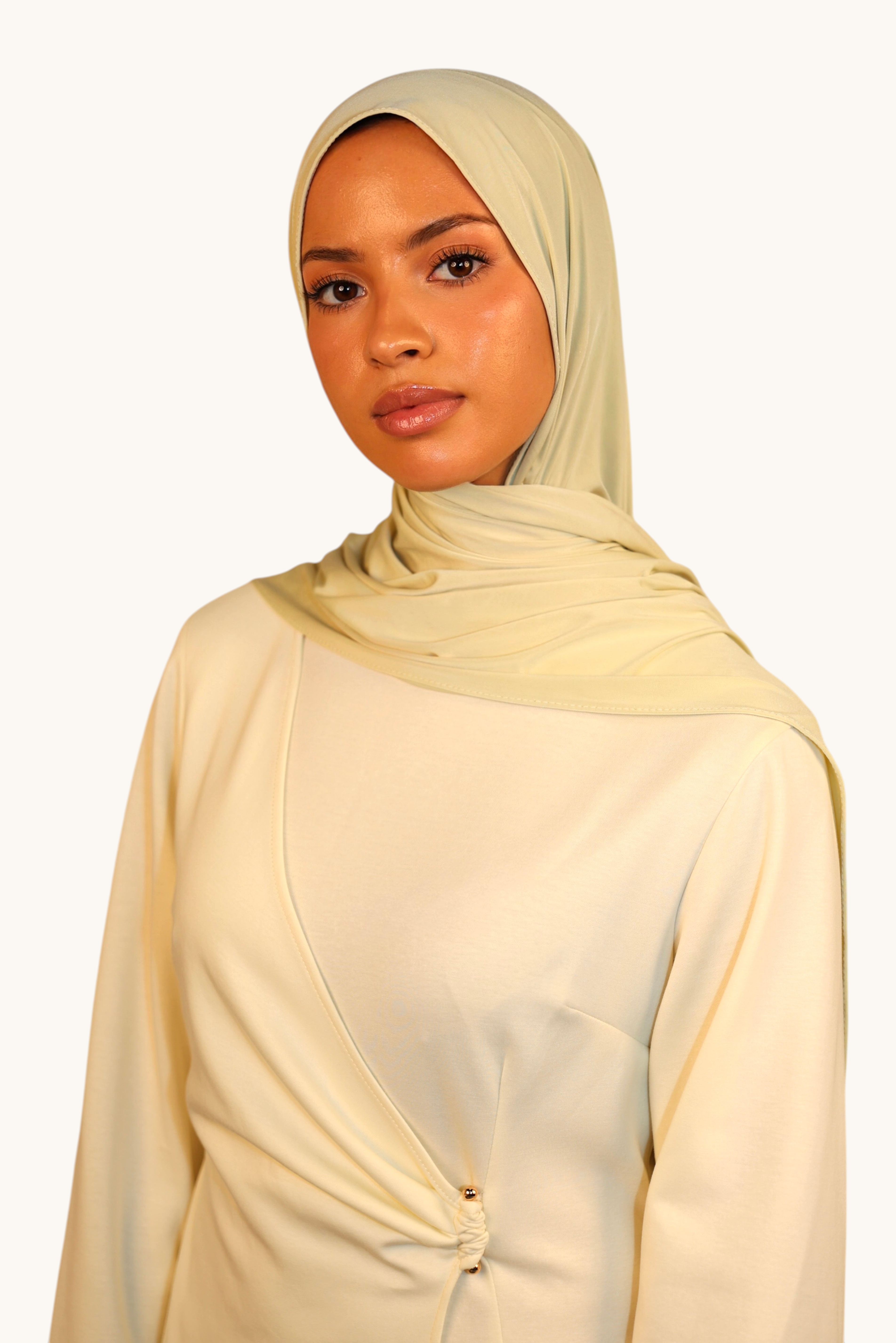 Model wearing a light lime LOSYANA Vela Jersey hijab, crafted from soft, breathable fabric for elegant styling.