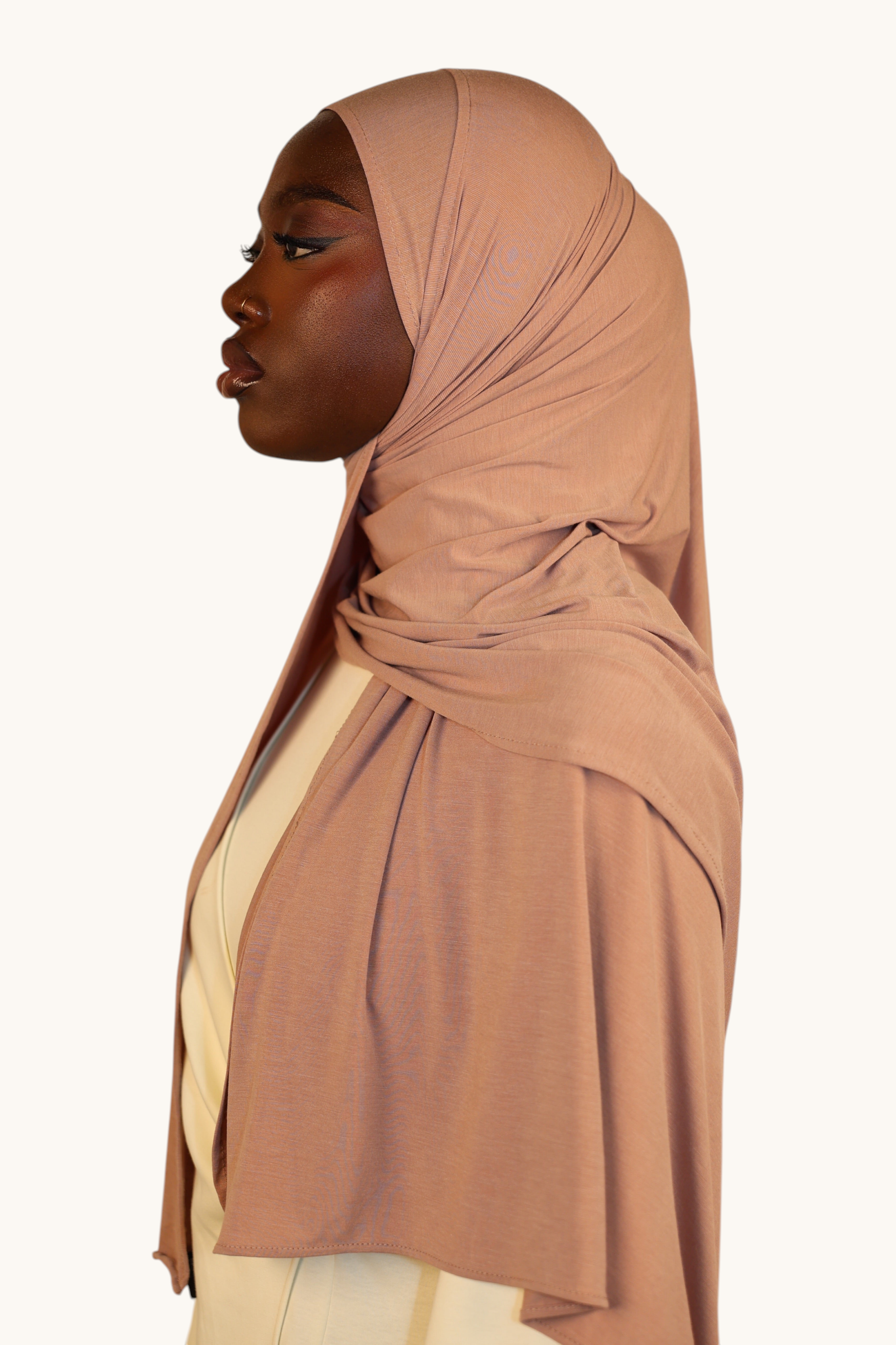 Model wearing an old rose LOSYANA Vela Jersey hijab, showcasing the soft, breathable fabric in a side profile view.