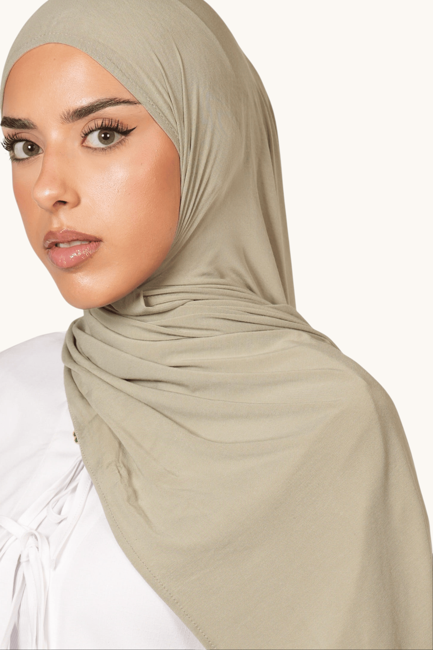 Model wearing a LOSYANA Vela Jersey in pistachio, a soft, lightweight, breathable fabric hijab in a muted green tone.