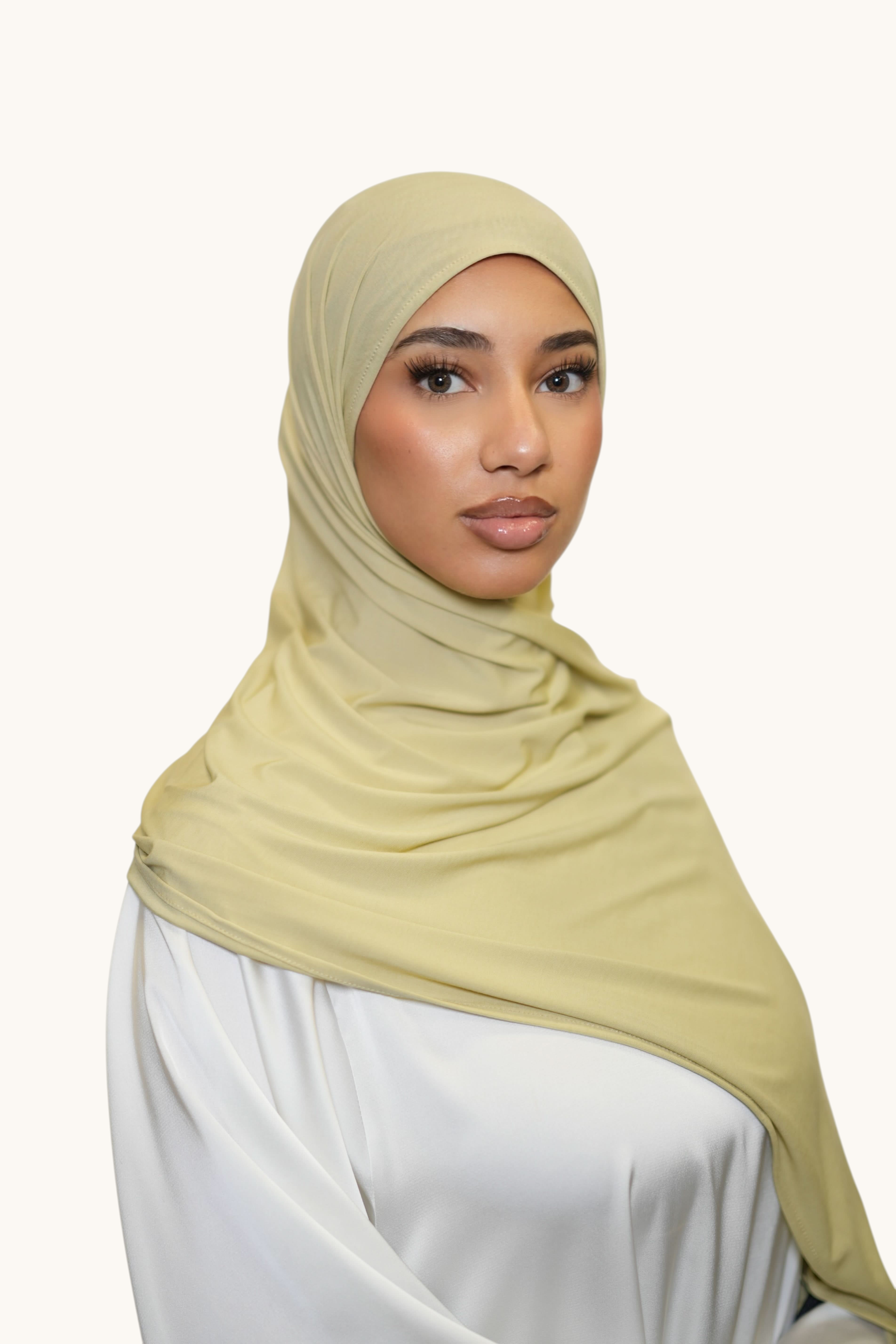 Model wearing a soft thyme LOSYANA Vela Jersey hijab, crafted from lightweight, breathable fabric for versatile styling.