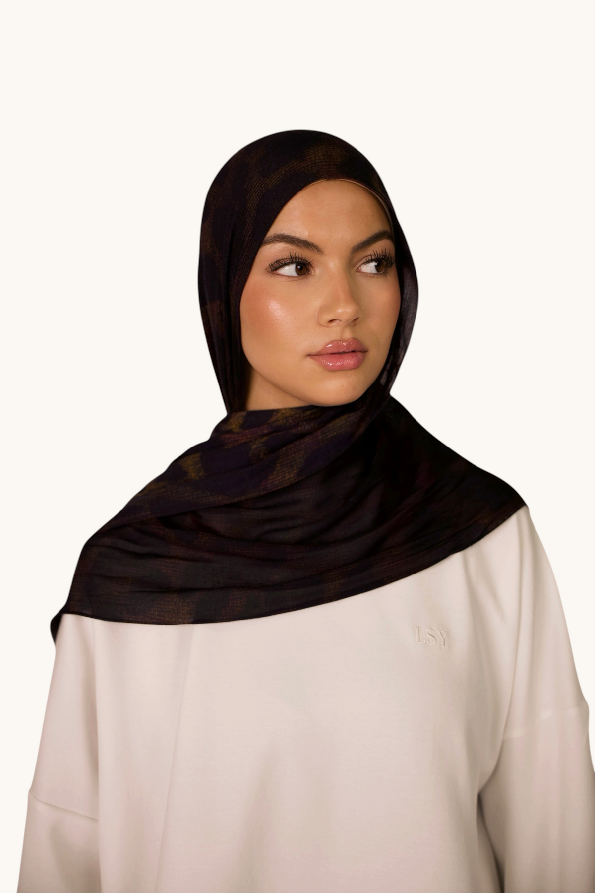 LOSYANA Hijab aus leichtem Modal in Dark Leopard Muster, getragen von einem Model mit weißem Oberteil