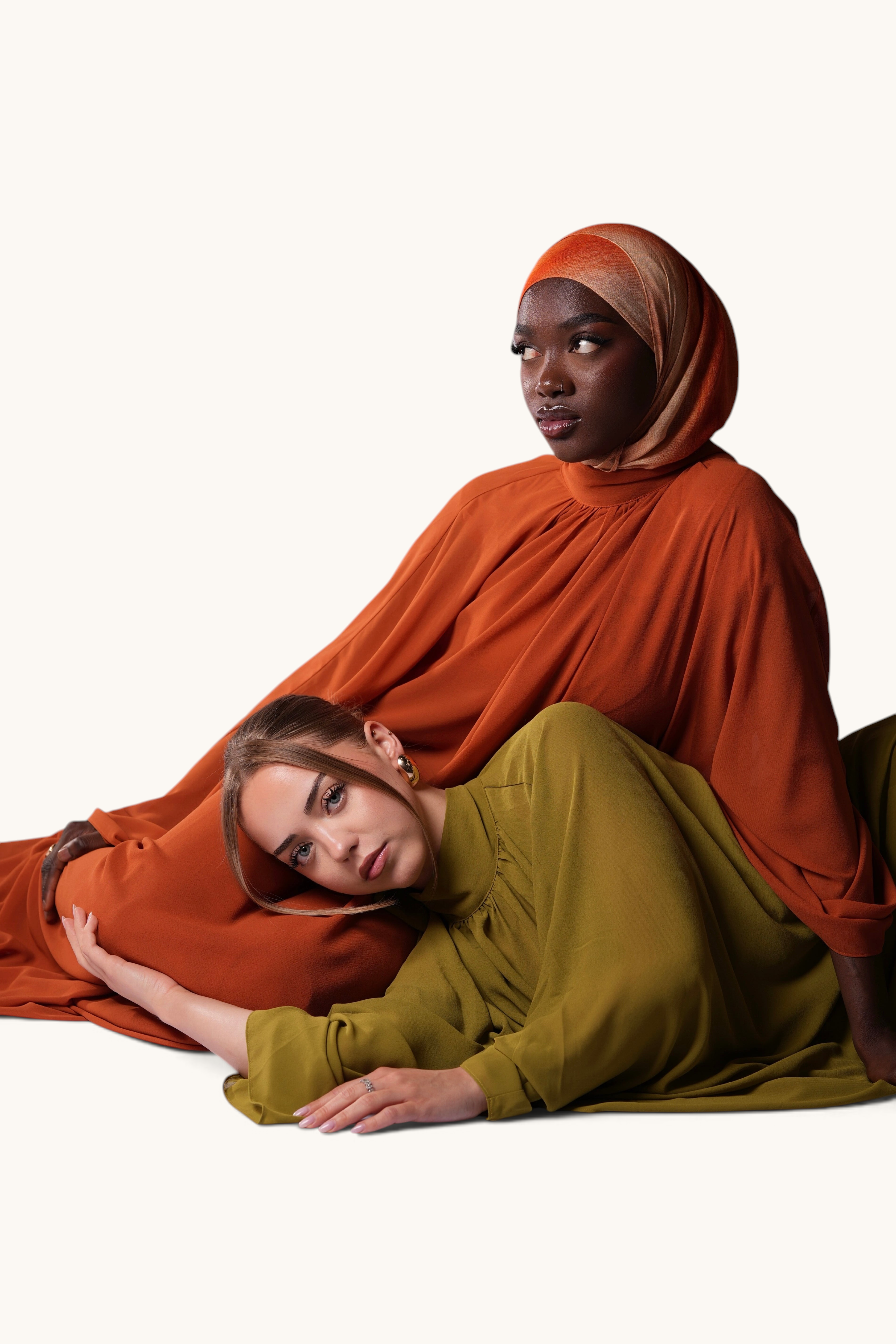 LOSYANA Andalusia chiffon cape dresses in sunset orange and olive green worn by two models on a white background