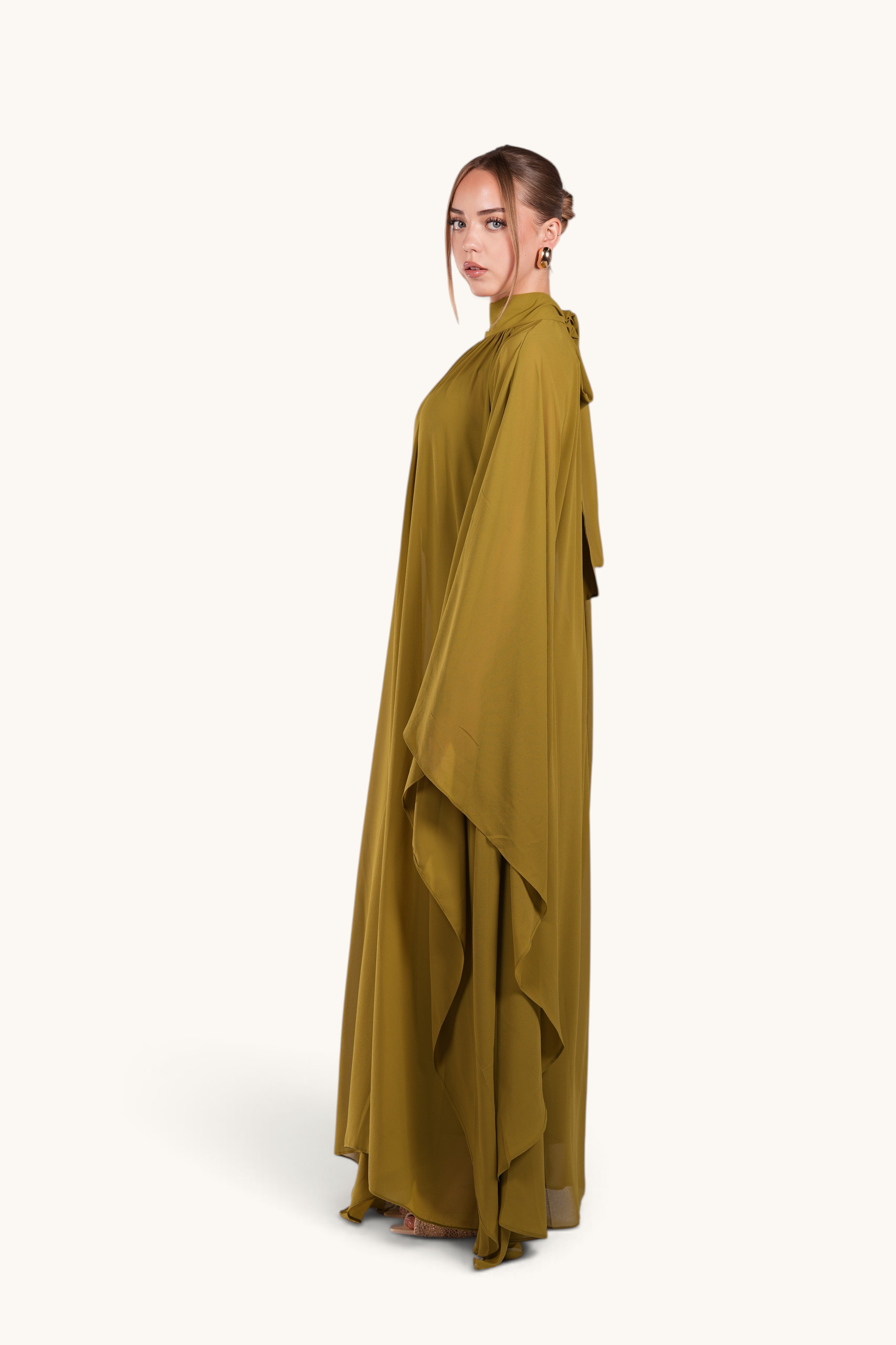 LOSYANA Andalusia lime green chiffon cape dress with elegant flowing silhouette worn by a model, side view
