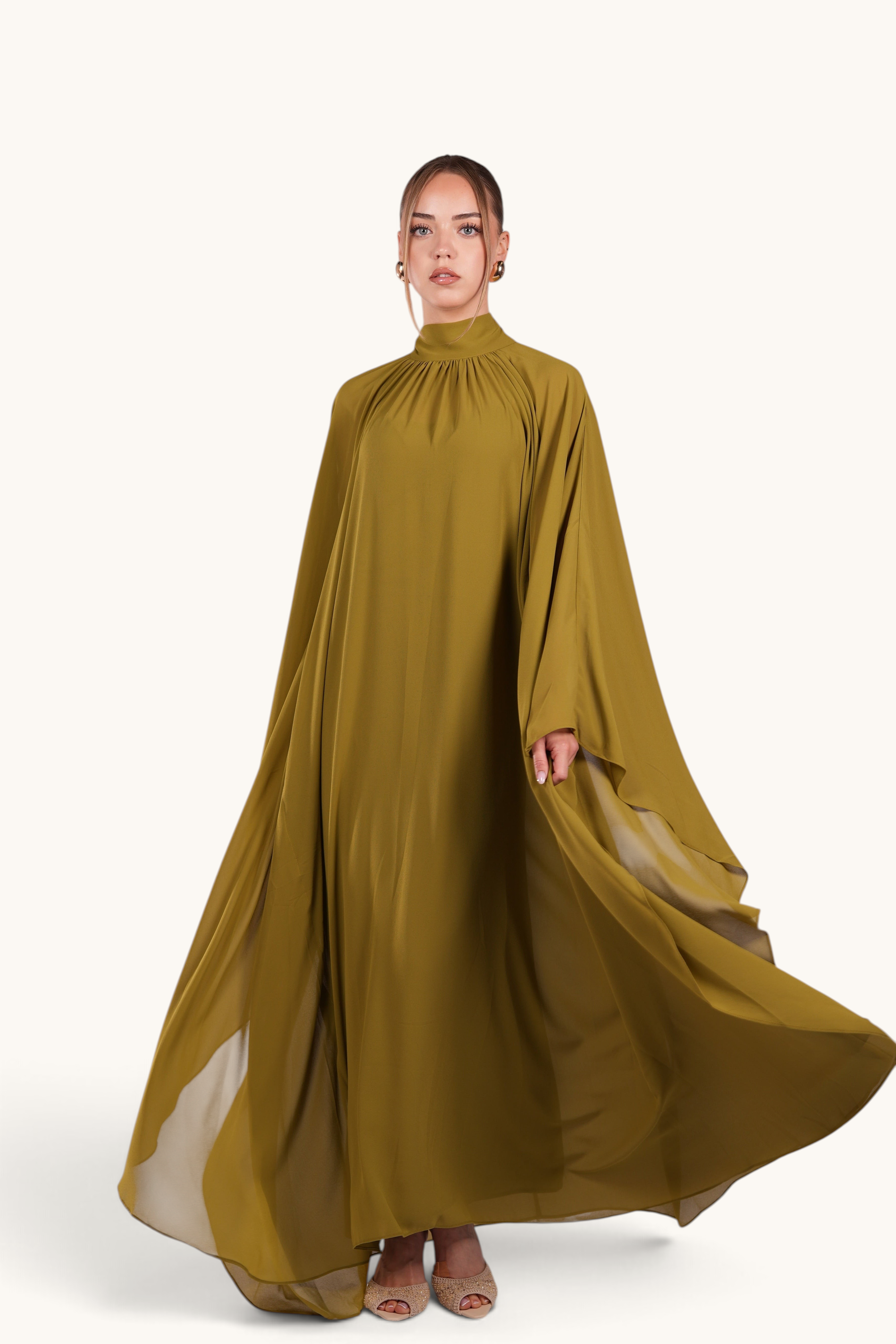 LOSYANA Andalusia lime chiffon cape dress with high neckline and flowing silhouette worn by a model