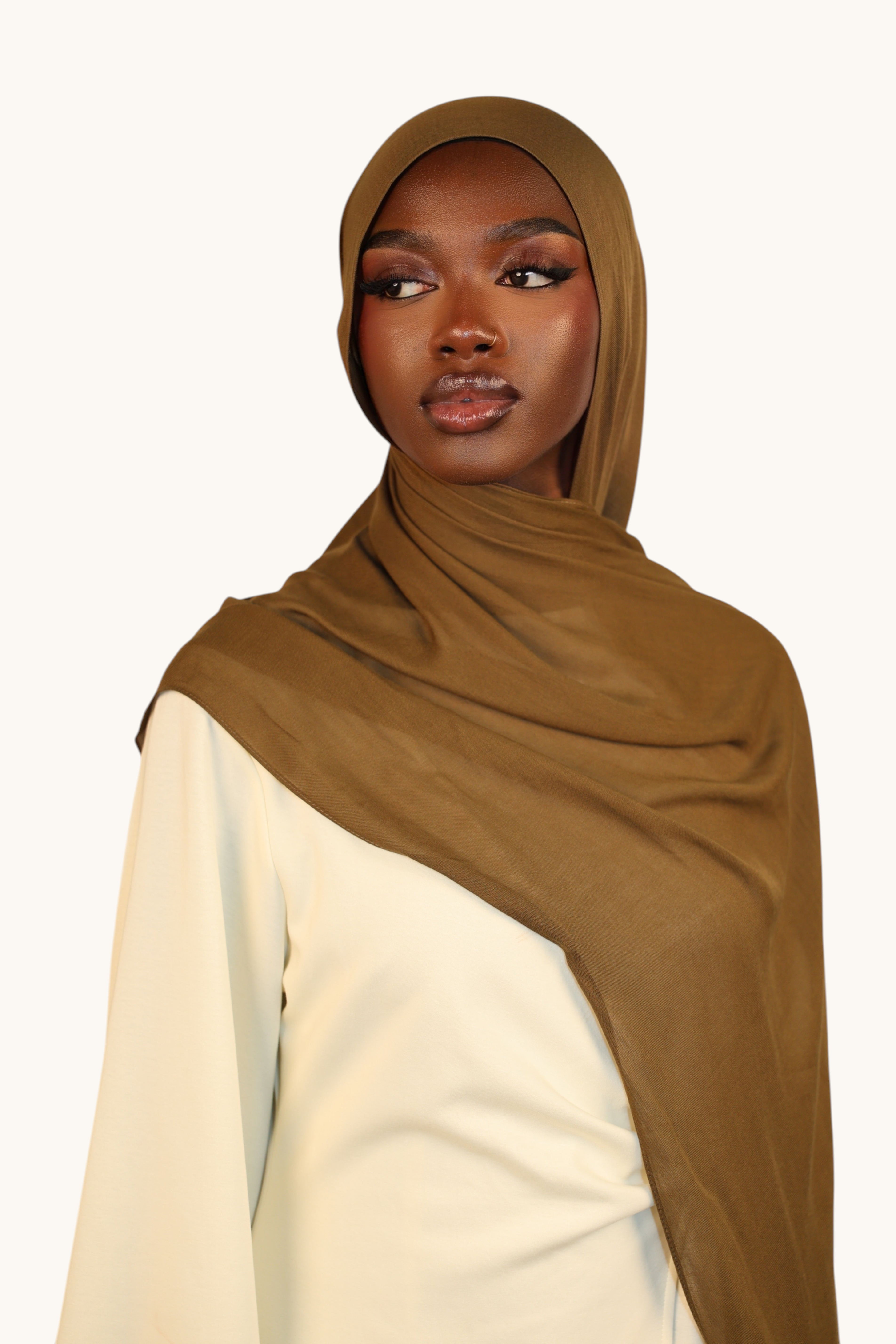 Model wearing a LOSYANA army green lightweight modal hijab with a soft, elegant drape and sheer finish.