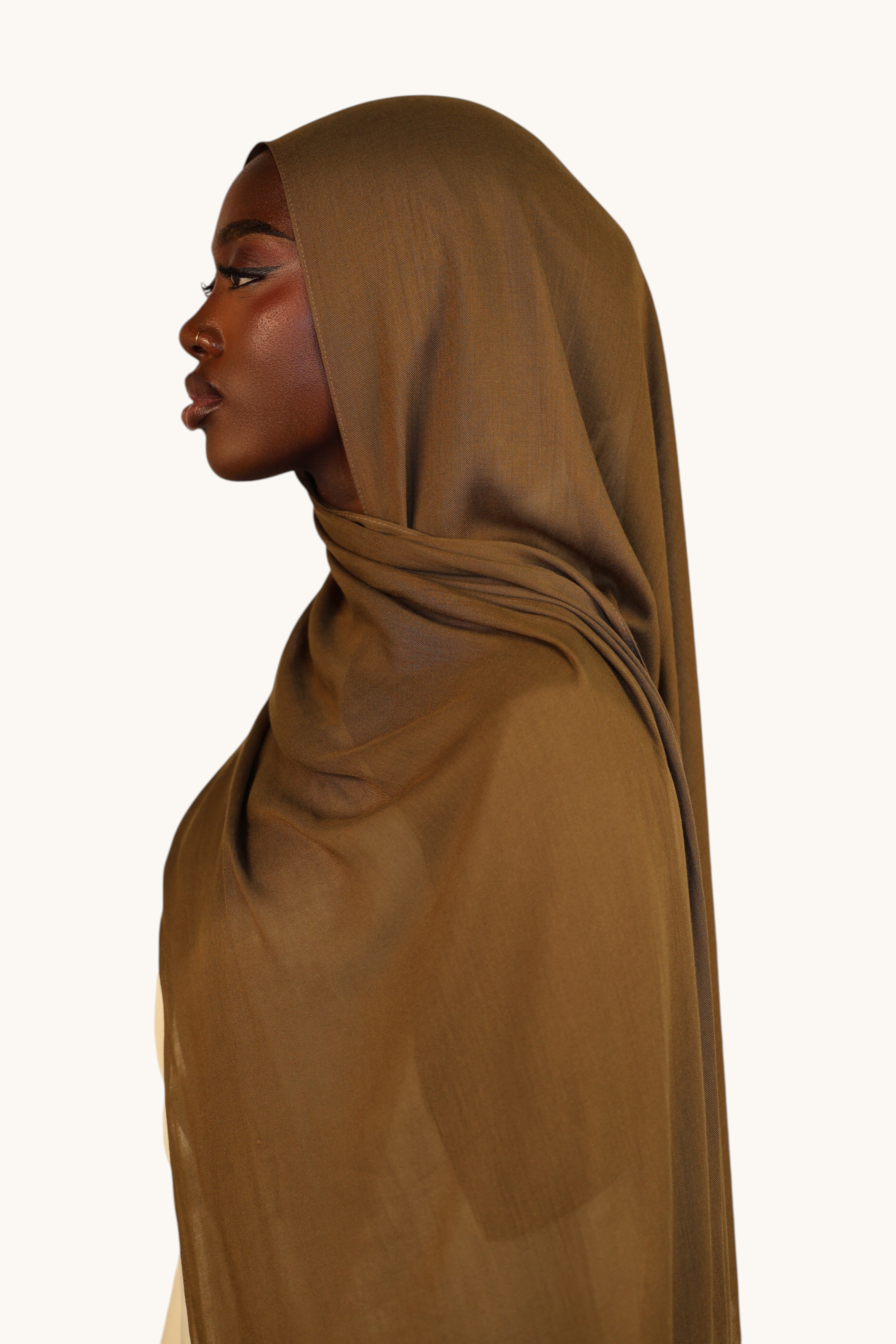 LOSYANA lightweight army green modal hijab worn by a model in profile view, featuring a soft and elegant drape.