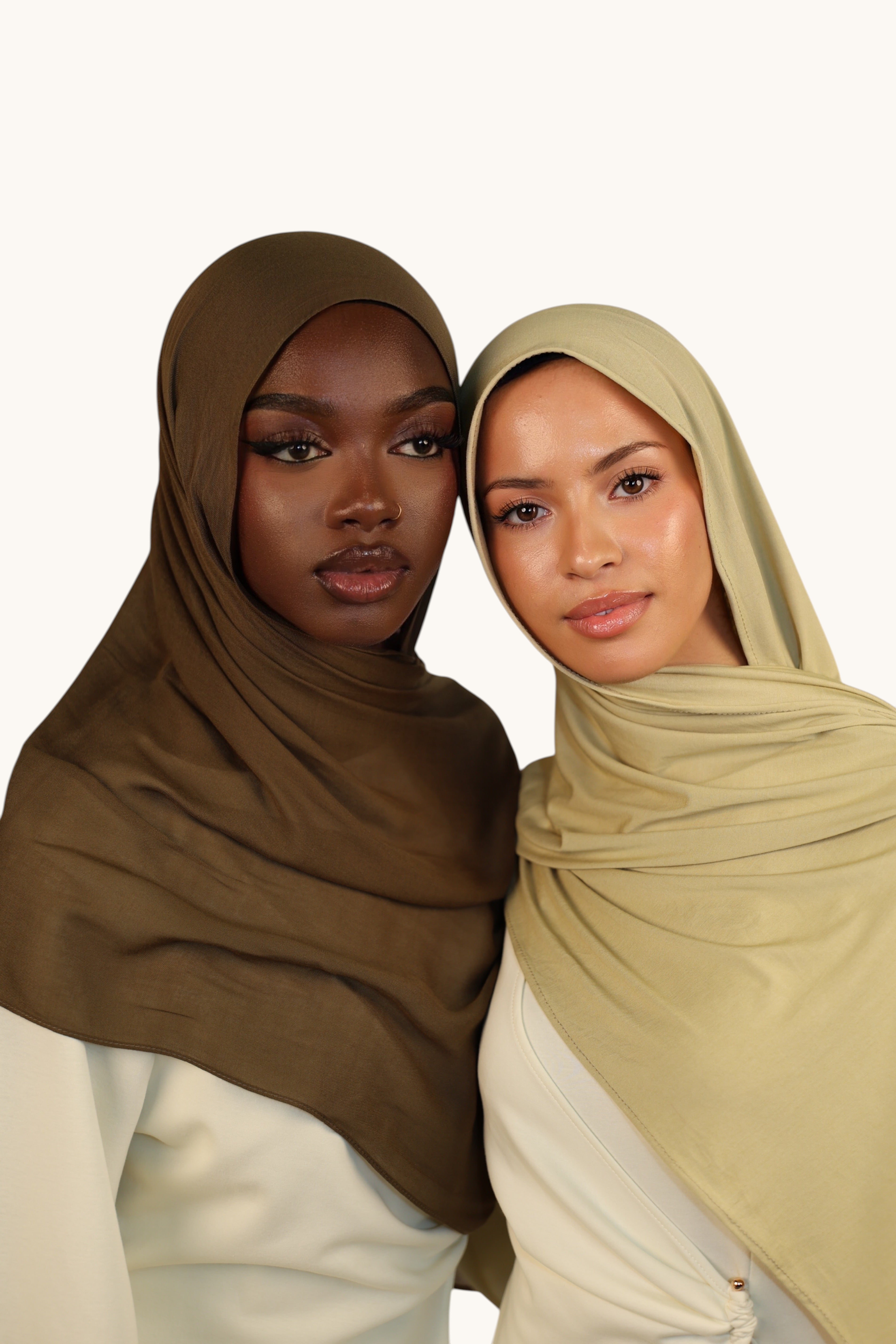 Two models wearing LOSYANA lightweight modal hijabs in army green and light sage green with matching undercaps
