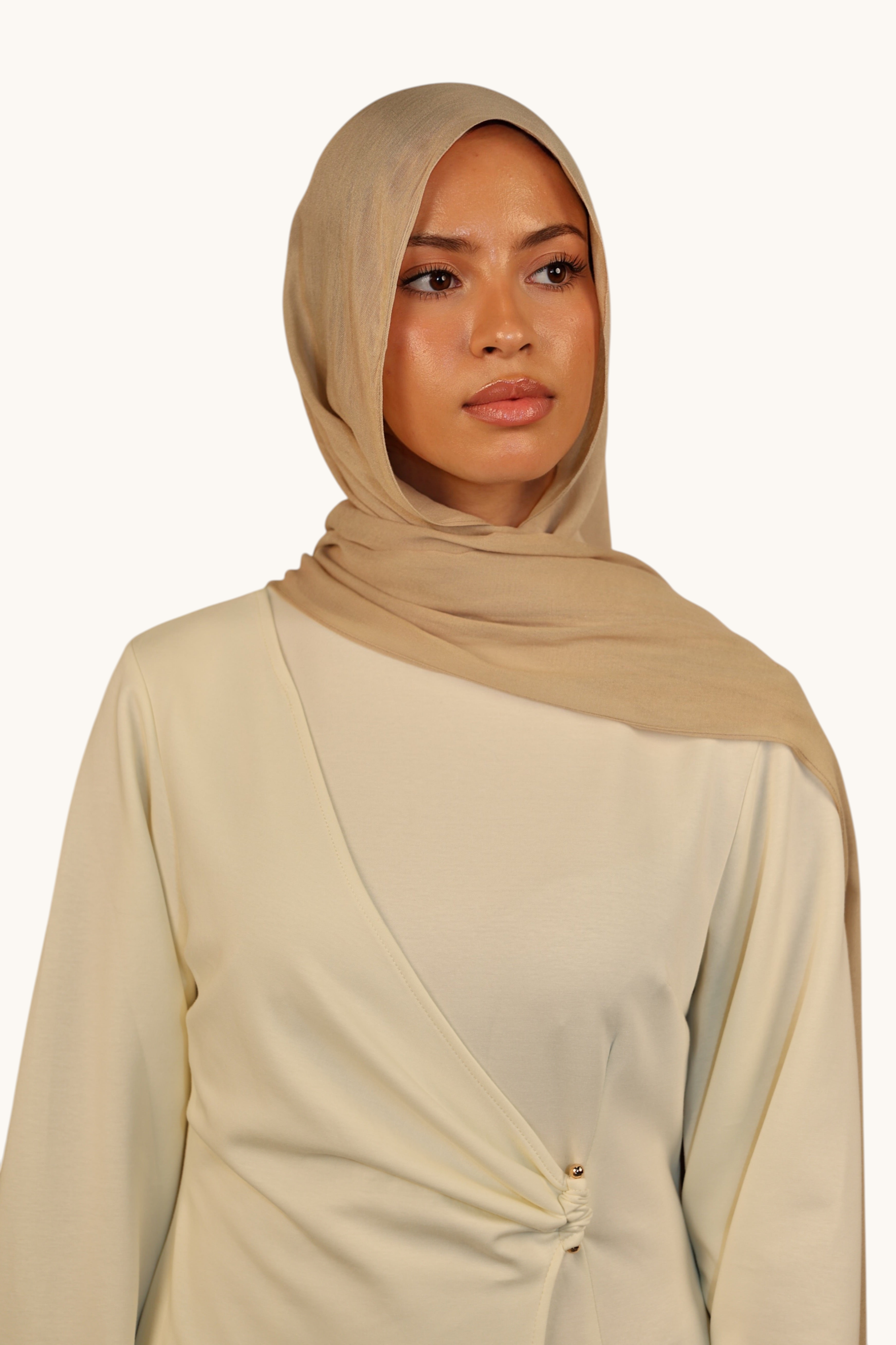 LOSYANA beige lightweight modal hijab worn by a model, featuring a soft, elegant drape and sheer finish.