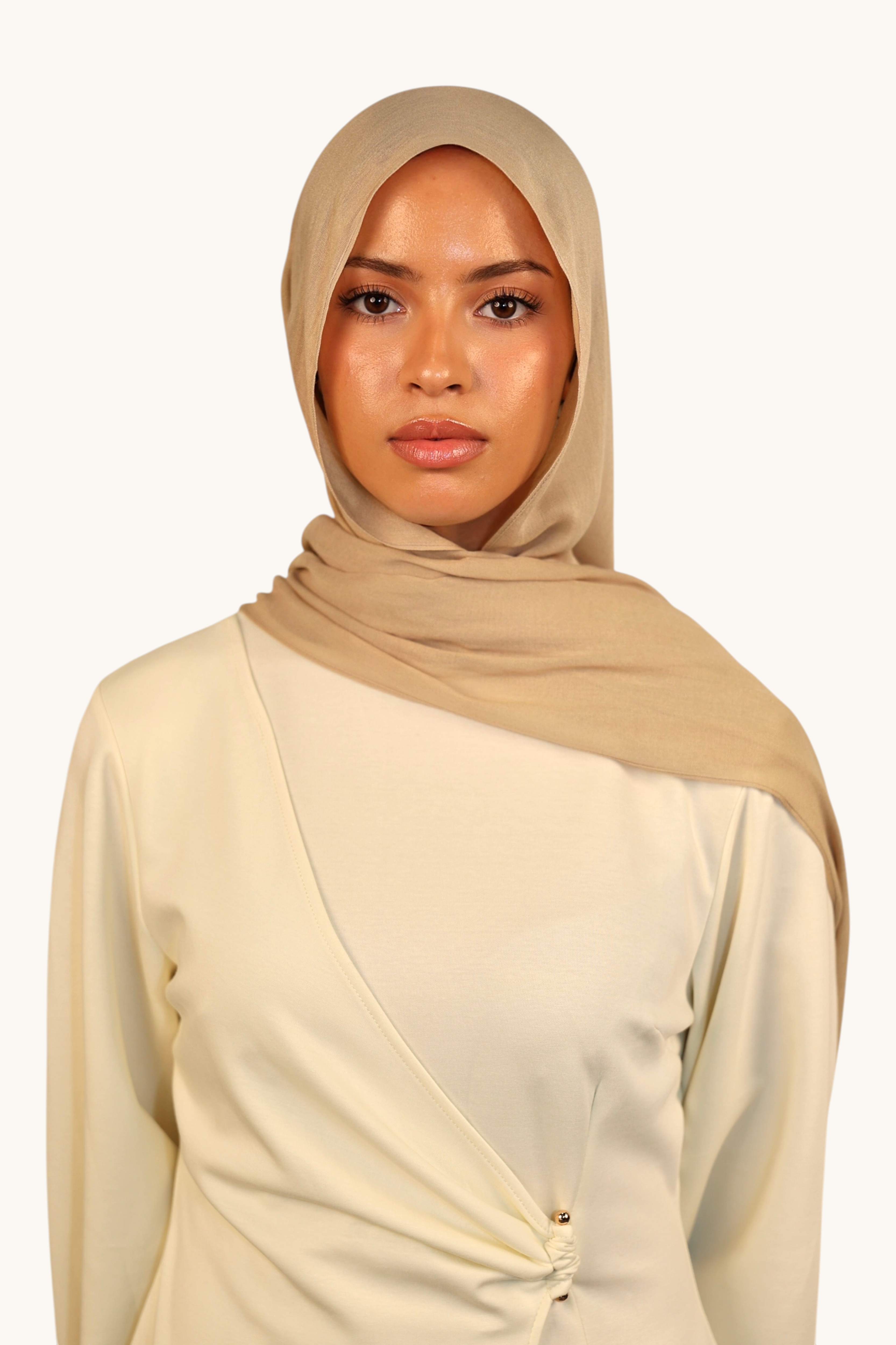 LOSYANA beige lightweight modal hijab worn by a model, featuring a soft, elegant drape and sheer finish.