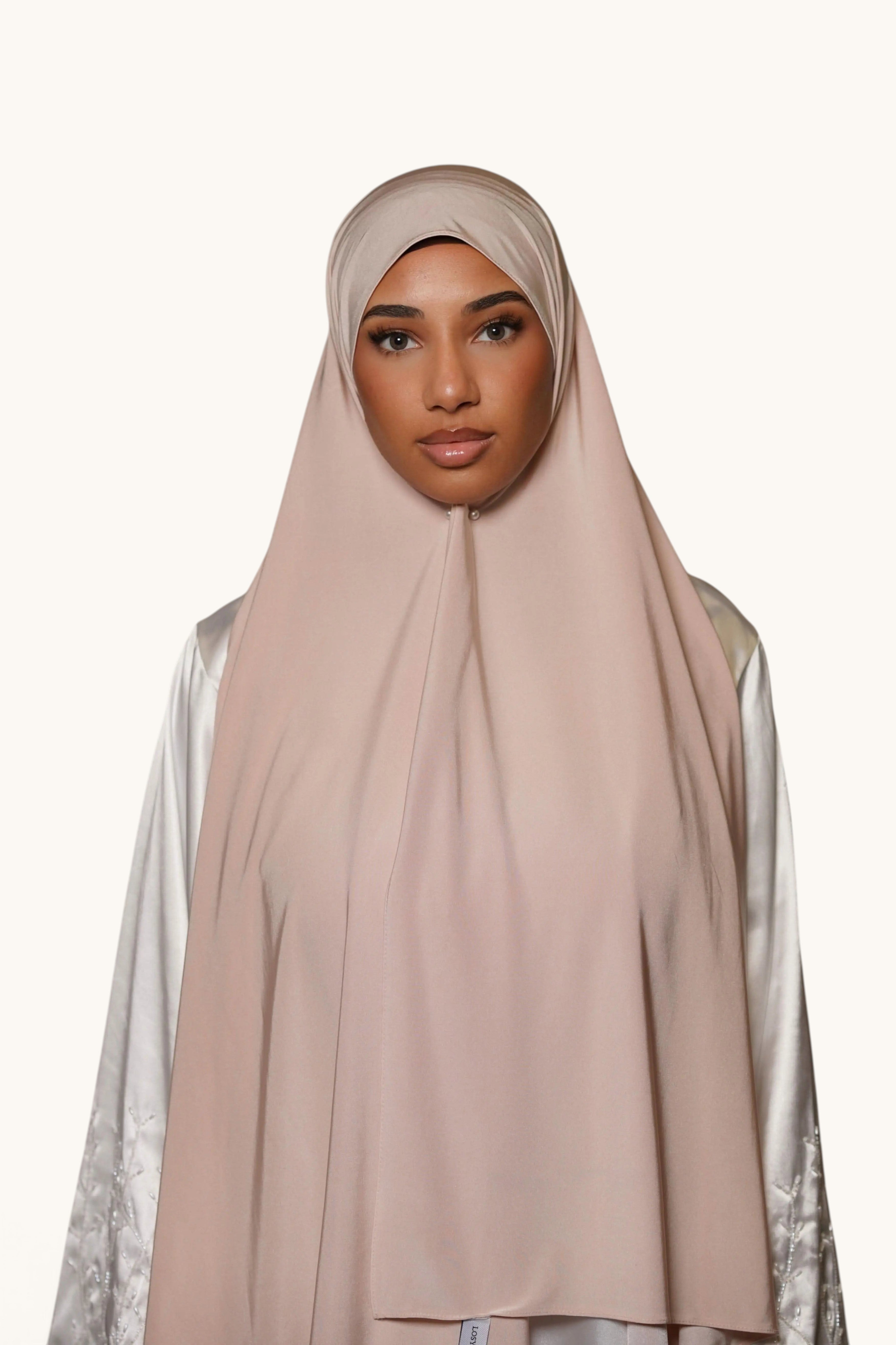 Model wearing a beige LOSYANA premium satin jersey hijab, featuring a non-slip, opaque fabric with elegant draping.