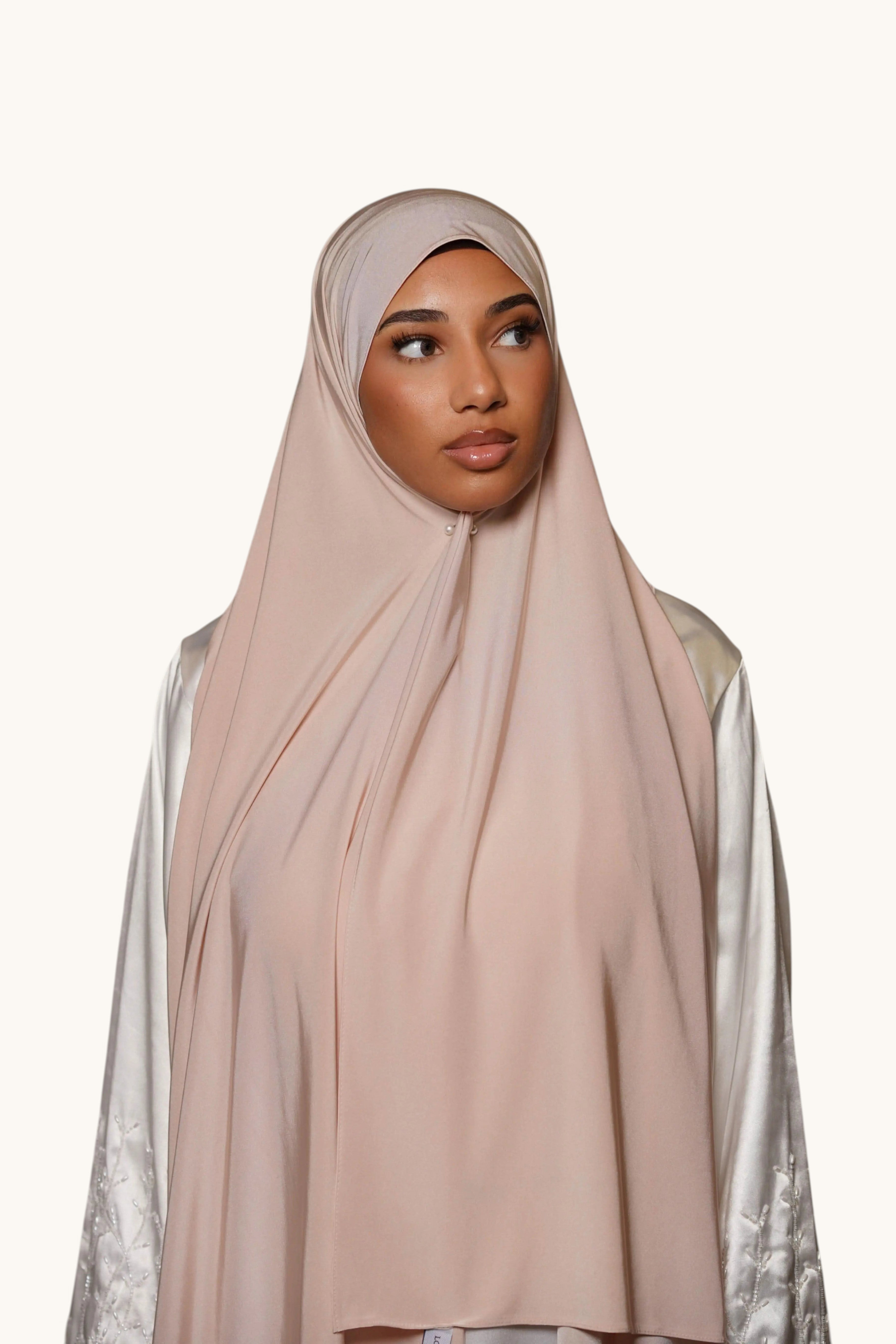Model wearing a beige LOSYANA satin premium jersey hijab with a smooth, non-slip drape against a white background.