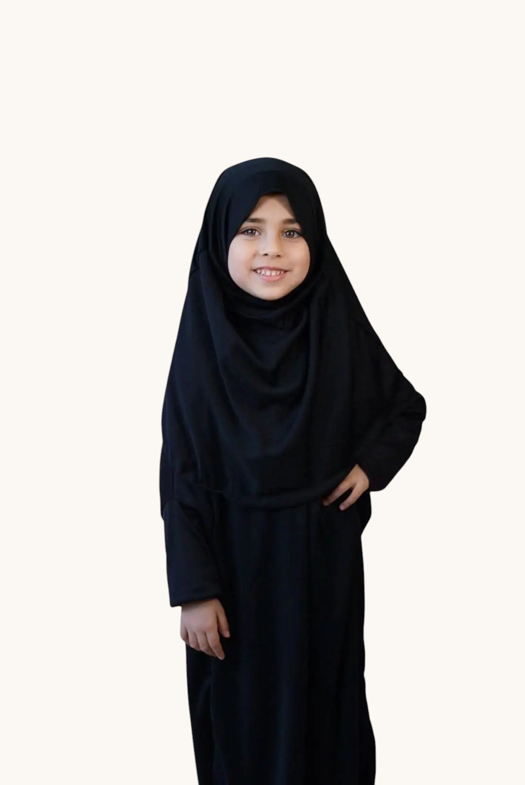 Young girl wearing a comfortable black LOSYANA jersey prayer dress with an integrated hijab for children.