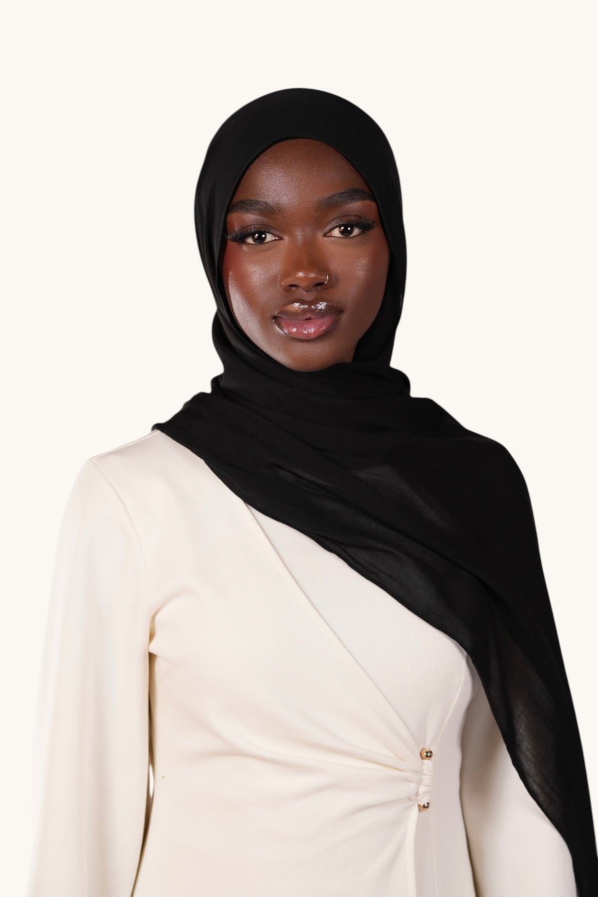Model wearing a LOSYANA lightweight black modal hijab with a soft, elegant drape against a white background.