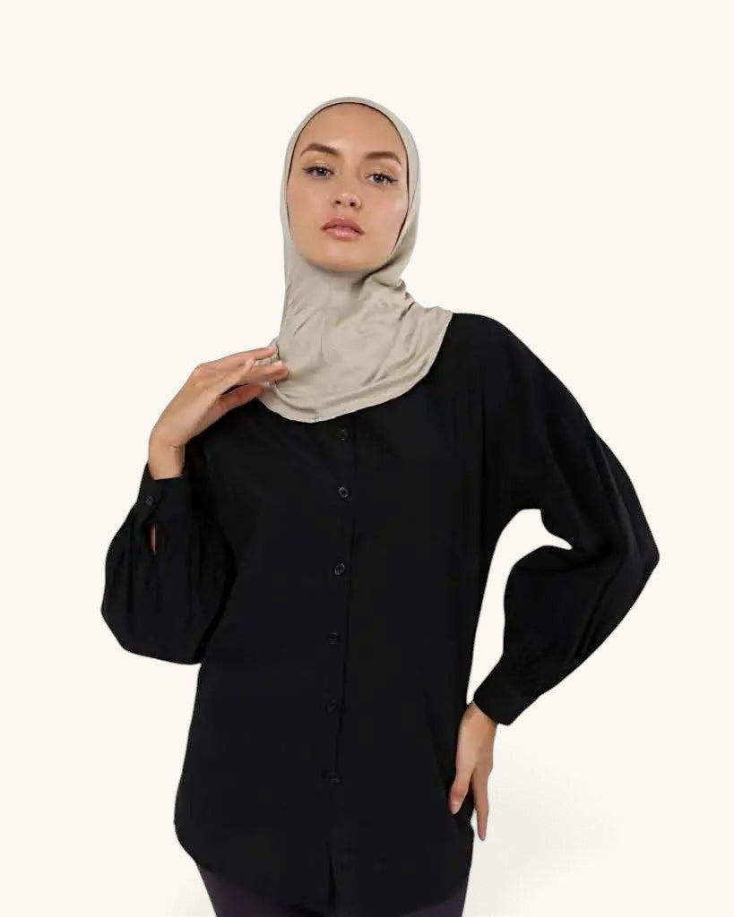 Model wearing a LOSYANA bone-colored ninja underscarf with a black button-down shirt