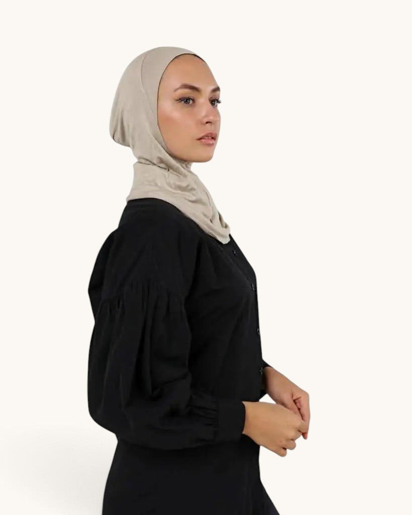 LOSYANA bone-colored ninja underscarf worn by a model in profile view, featuring a comfortable full-coverage fit.