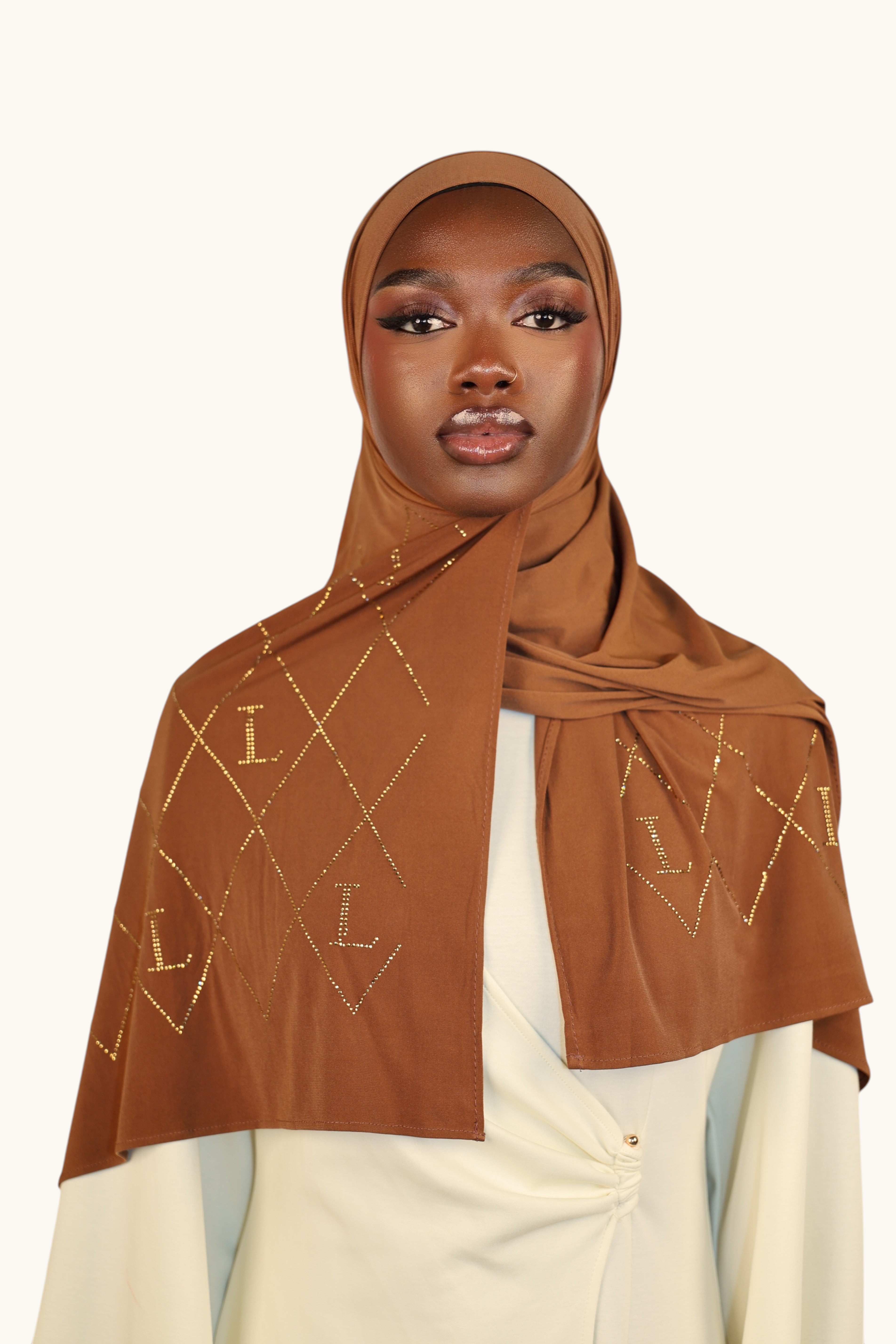 Model wearing a bronze LOSYANA premium jersey hijab with sparkling rhinestone L-pattern embroidery