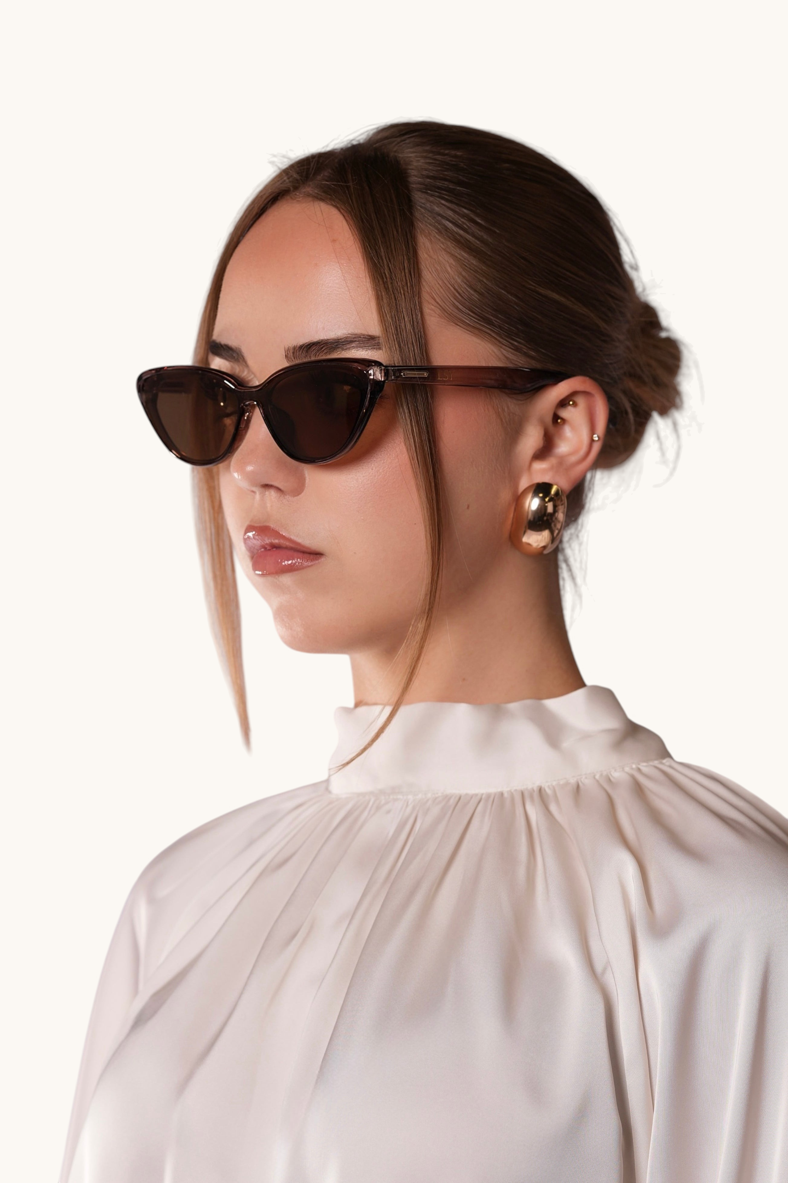 LOSYANA brown cat-eye sunglasses worn by a woman in a white blouse, providing UVA and UVB protection.