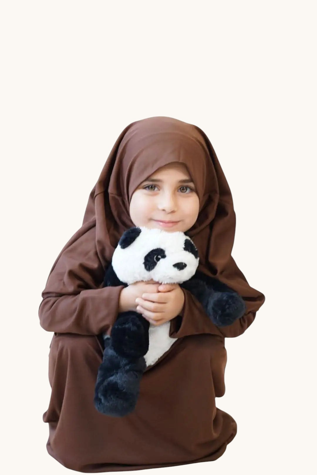 LOSYANA brown jersey prayer dress for children worn by a young girl holding a panda plush toy