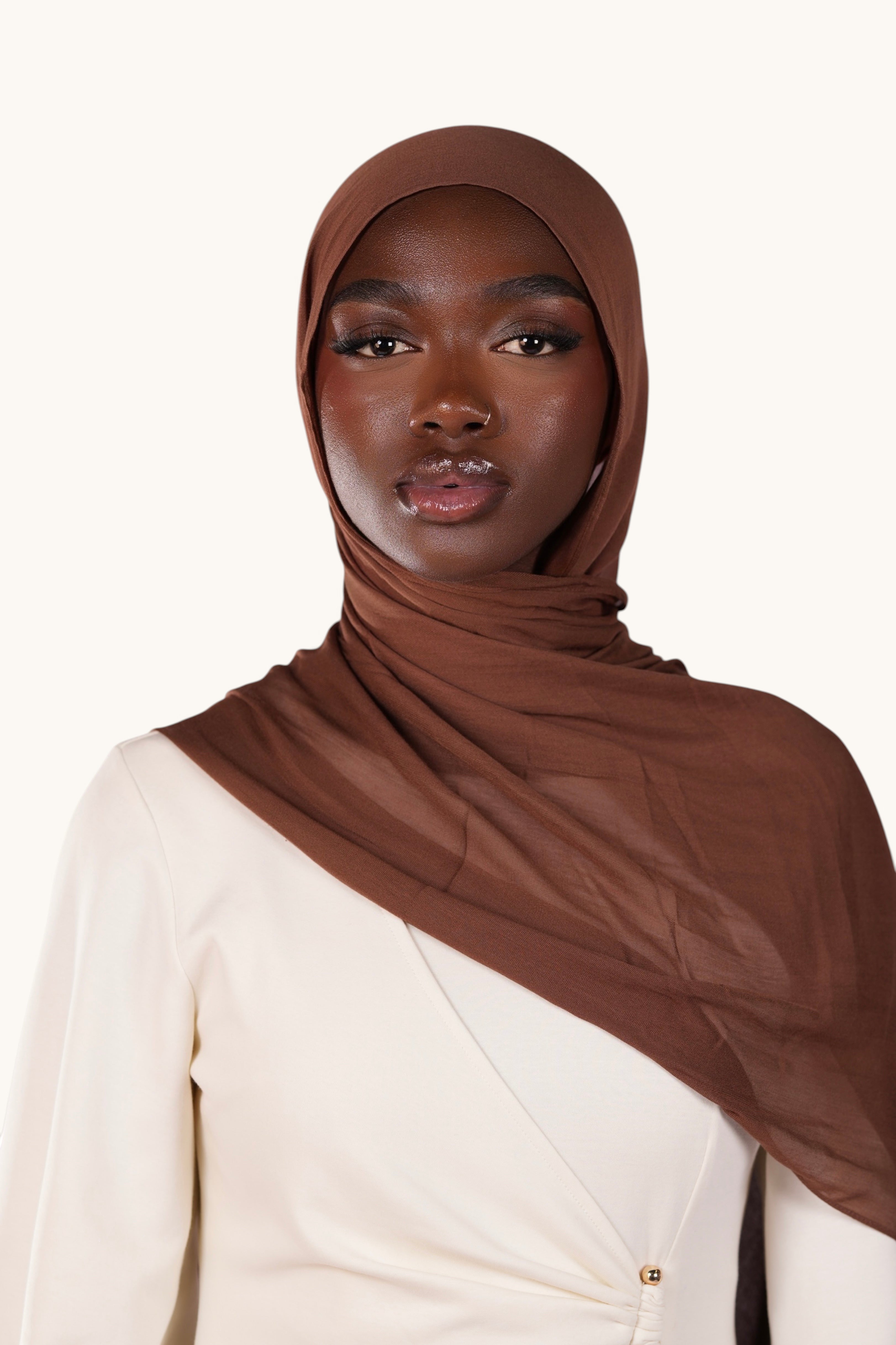 Model wearing a lightweight chocolate brown LOSYANA modal hijab with a soft, elegant, and slightly sheer drape.