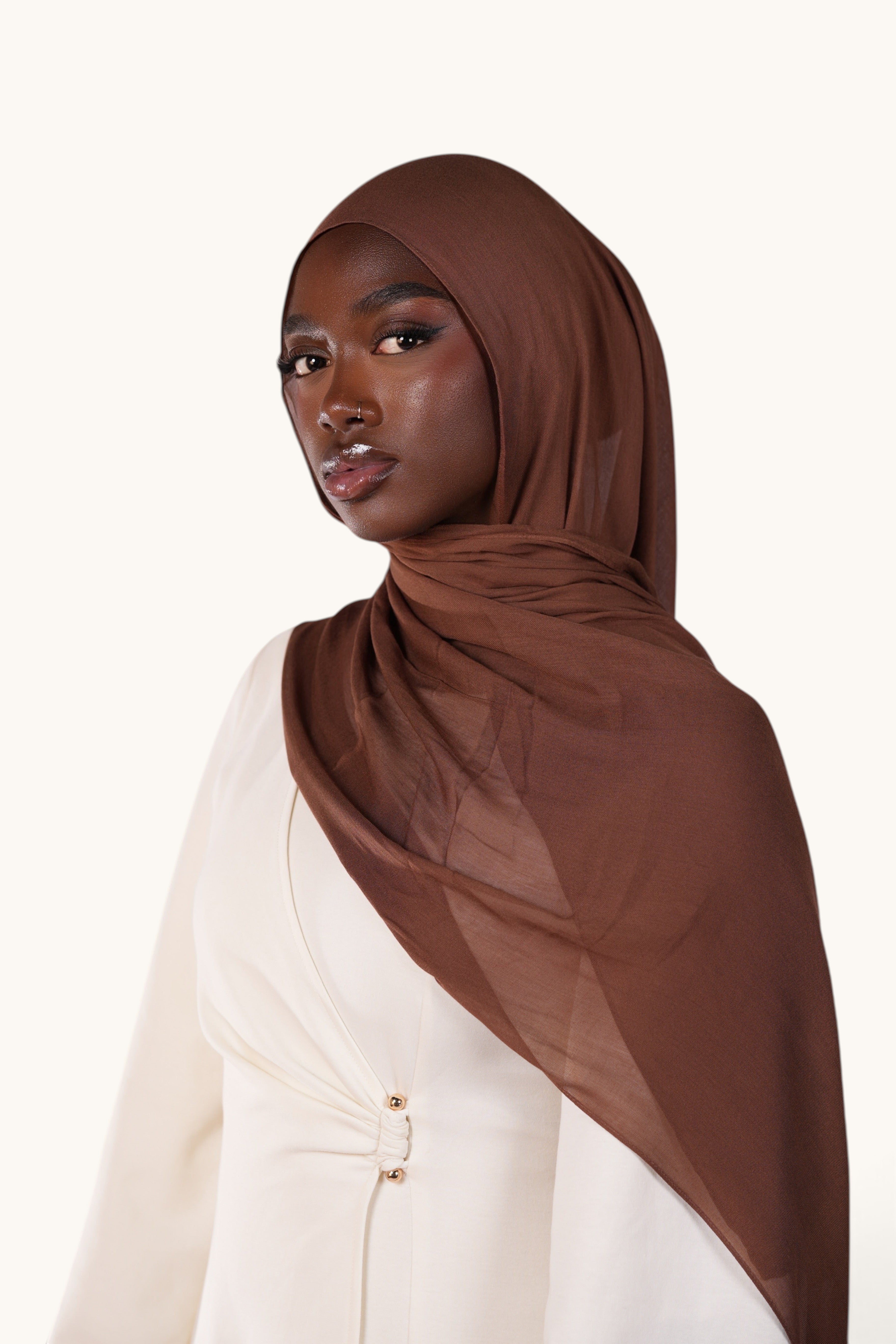 Model wearing a chocolate brown LOSYANA lightweight modal hijab with a soft, elegant, and semi-sheer draped finish.